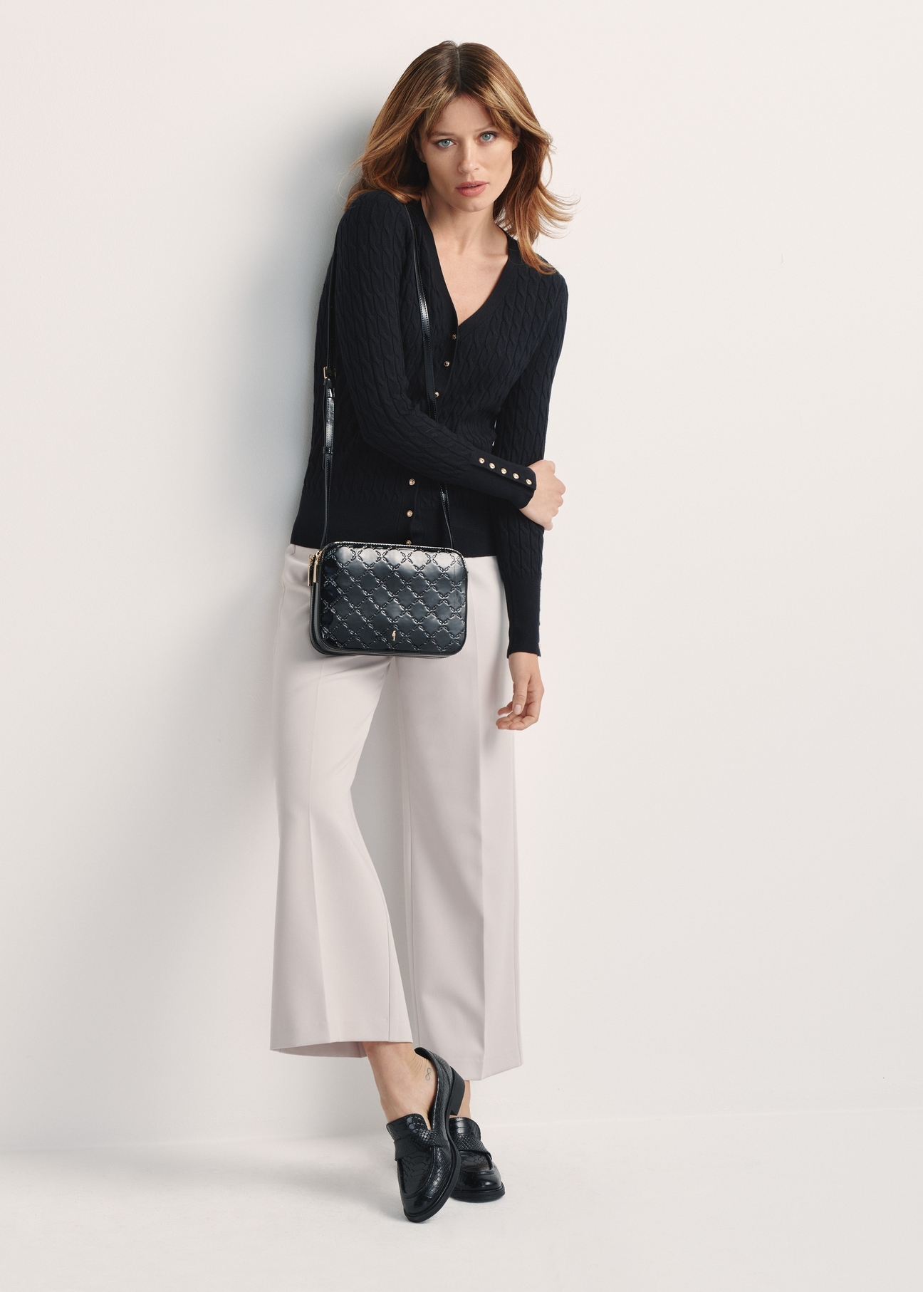 Black patent leather women's messenger bag TOREC-0205F-97(Z25), product view on the model's silhouette.