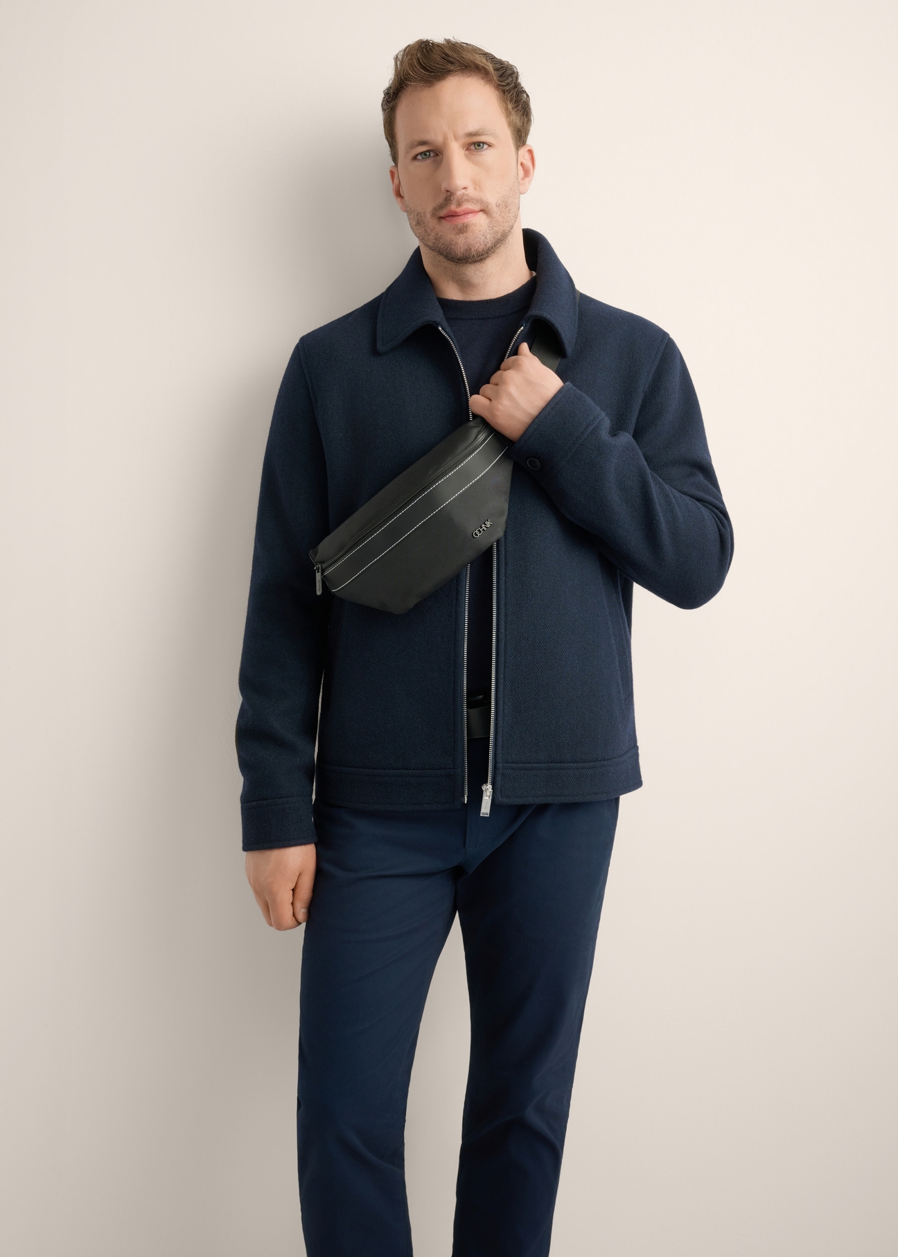 Men's black waist bag TORMN-0424-99(Z26), front view of the product on the model, half of the silhouette visible.