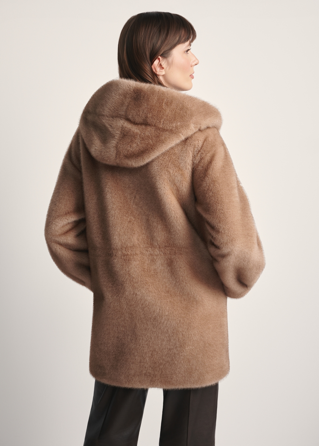 Beige women's fur coat with hood FUTDP-0062-81(Z25), back view of the product on the model. Half of the silhouette visible.