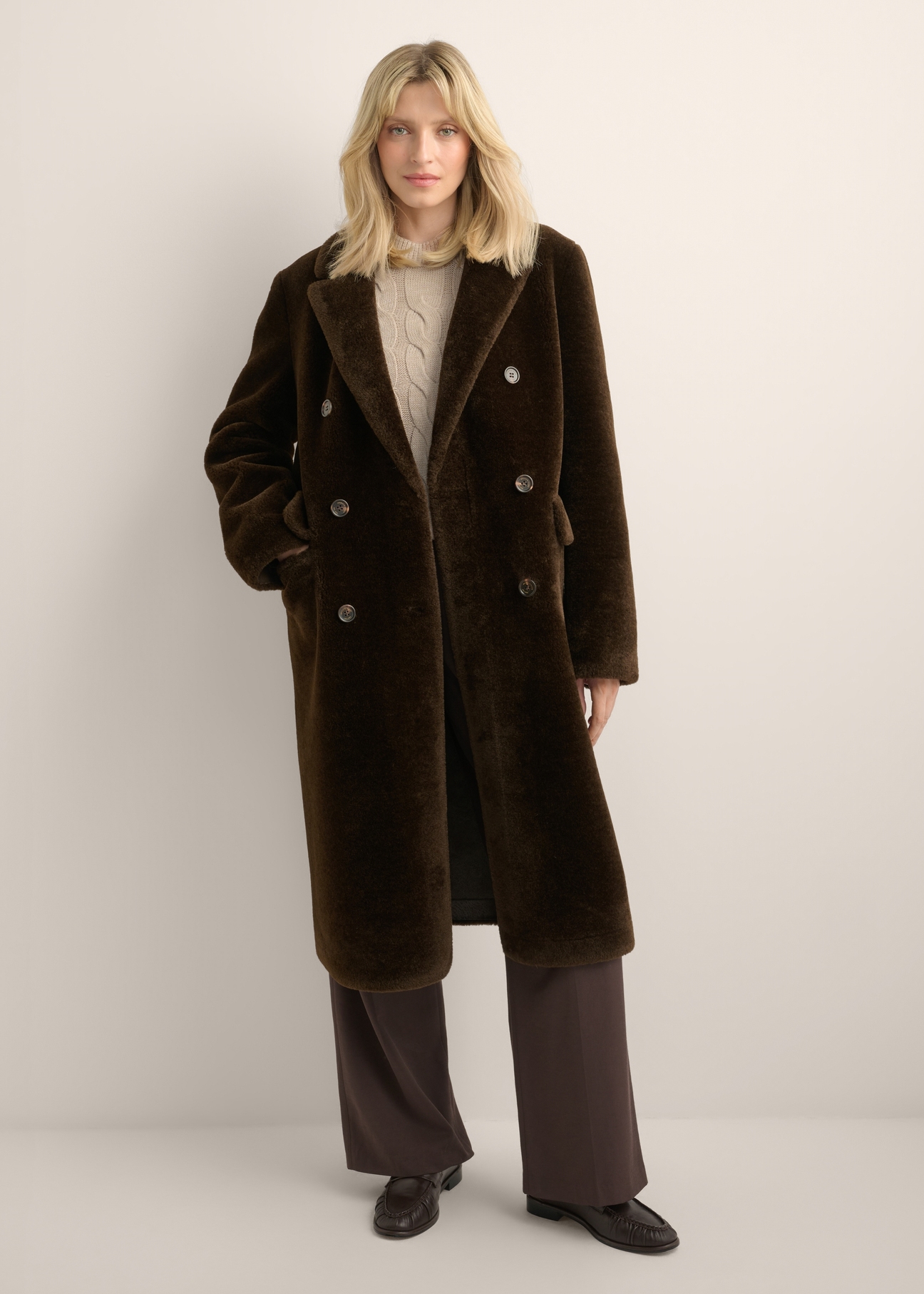 Women's long brown fur coat FUTDP-0087-1I(Z26) - front view of the product, on a model, against a light background. The entire silhouette is visible.