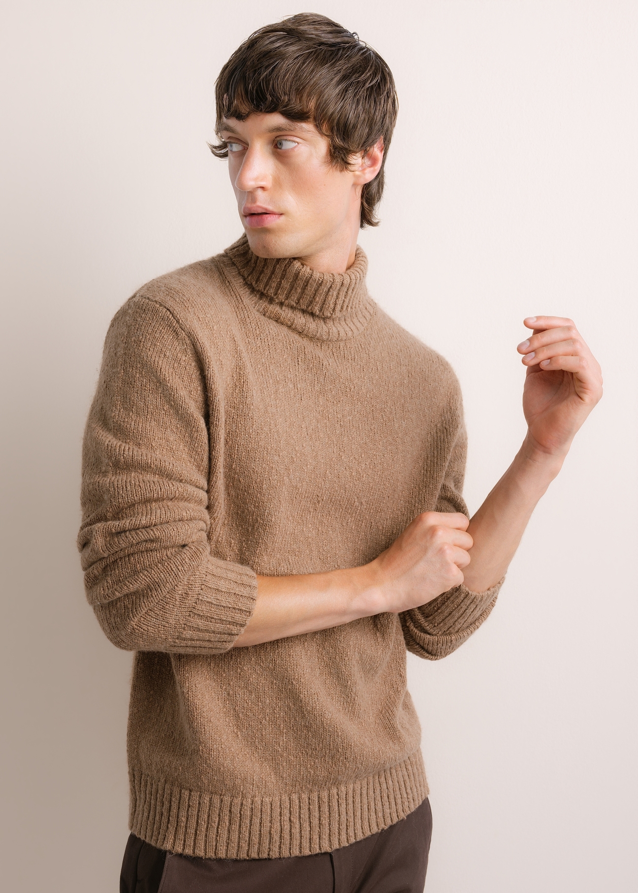 Men's turtleneck sweater in camel color SWEMT-0209-1D(Z26), diagonal product view on model. Half of the silhouette visible.