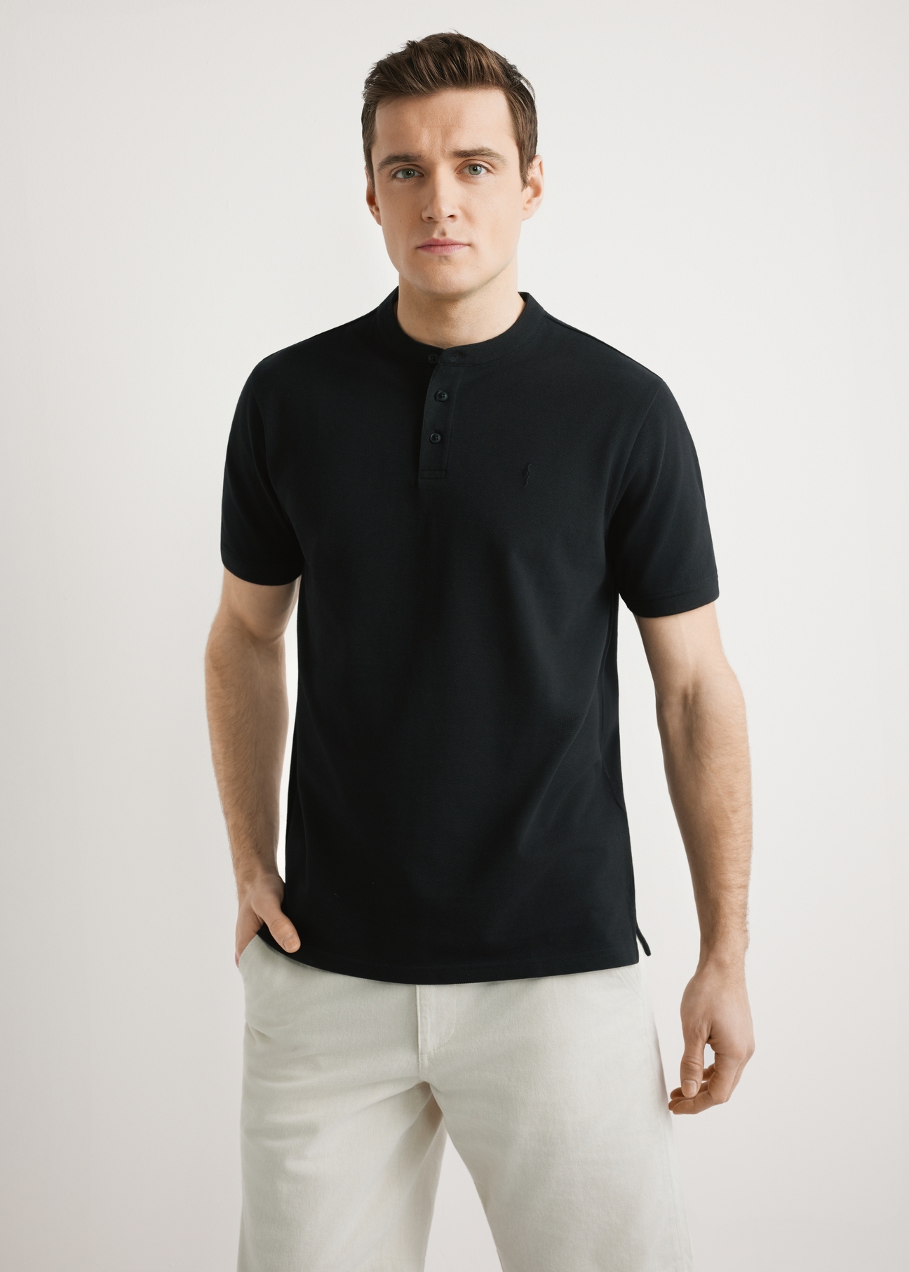 Men's black polo shirt POLMT-0095-99(W26), front view of the product on the model. Half of the silhouette visible.