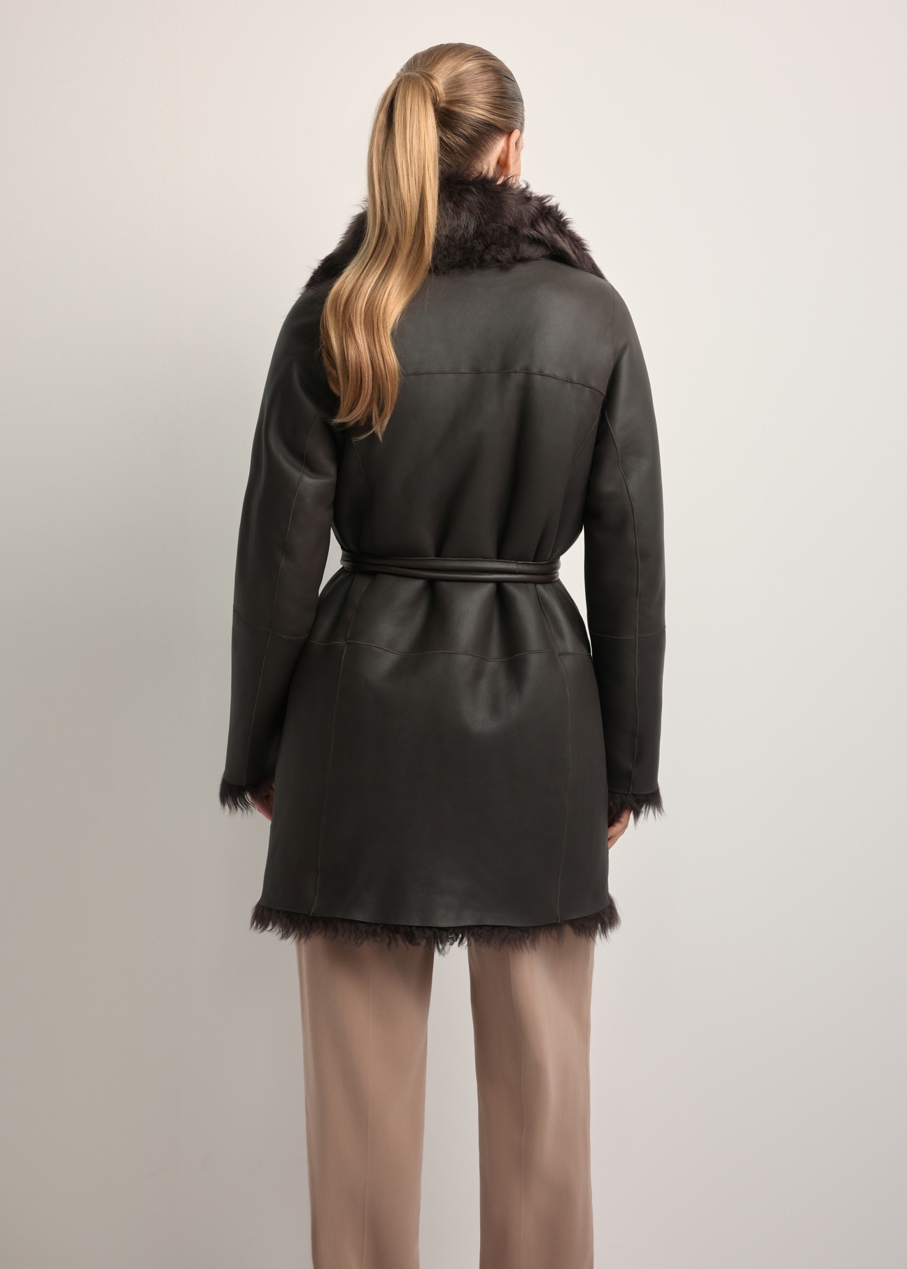 Women's brown double-sided leather sheepskin coat KOZDS-0090-1393(Z25), back view of the product on the model. Half of the silhouette visible.