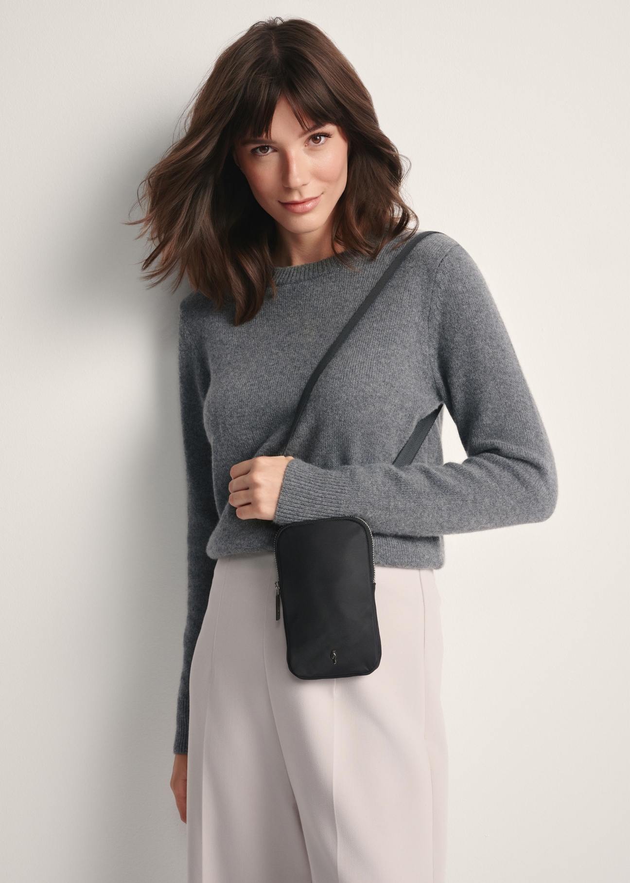 Black fabric women's bag TOREN-0331-99(Z25) - front view of the product on a model against a white background. Knee-length silhouette visible.