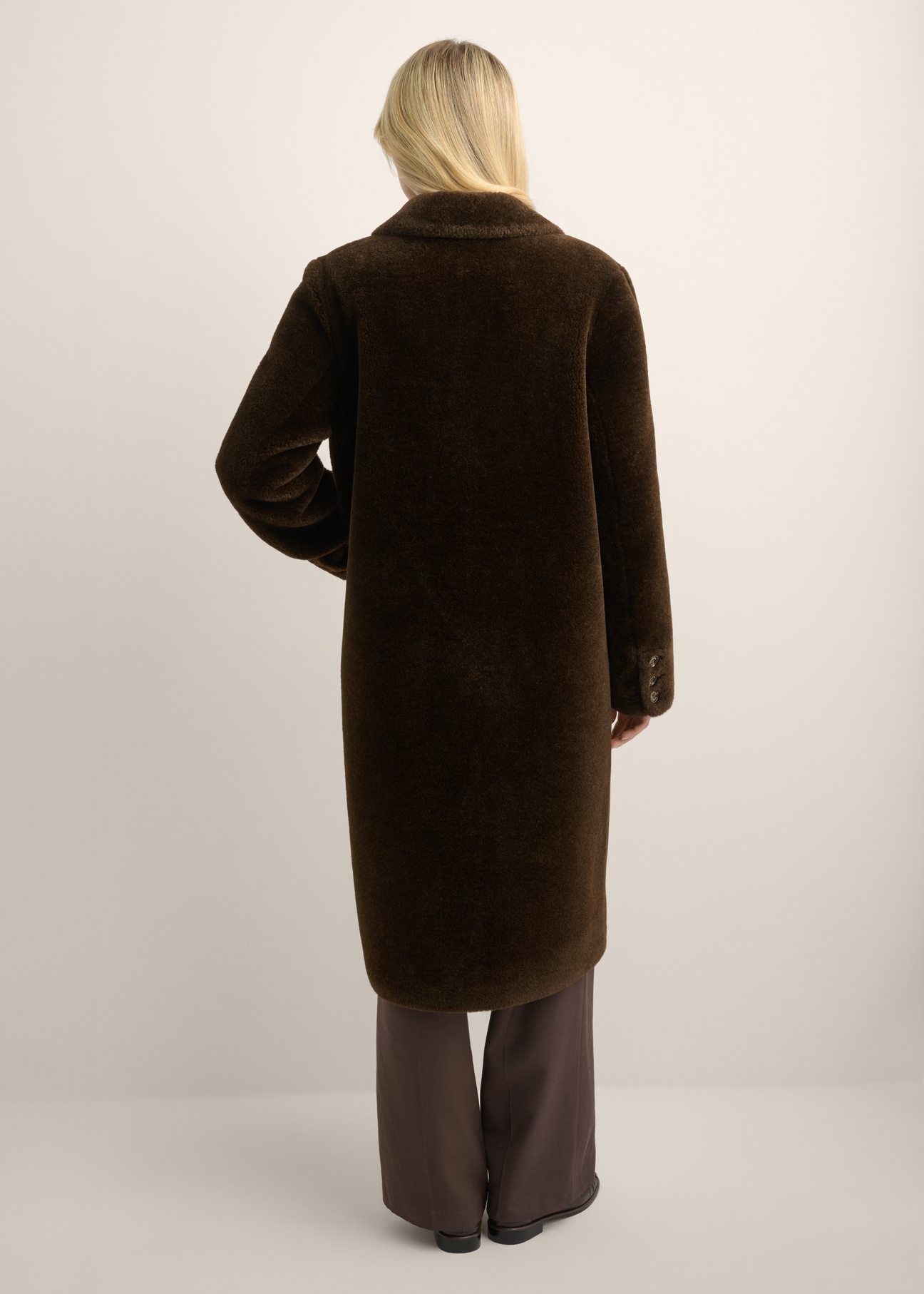 Women's long brown fur coat FUTDP-0087-1I(Z26) - back view of the product, on a model, against a light background. The entire silhouette is visible.