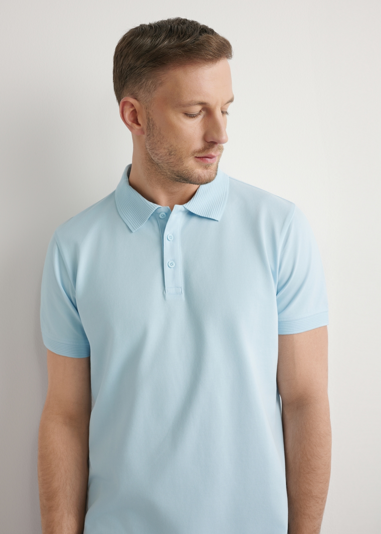 Men's light blue polo shirt POLMT-0089-7A(W26), front view of the product on the model. Half of the silhouette visible.