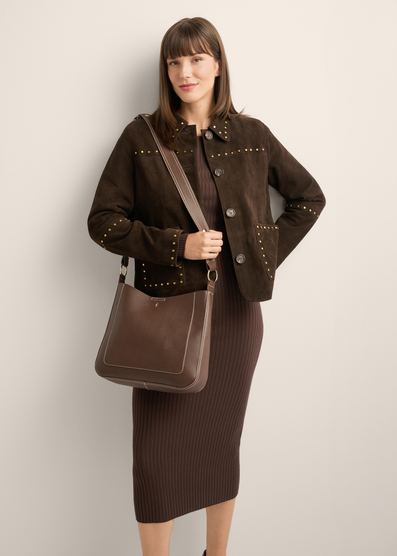 Brown women's hobo bag TOREC-1257-1H(Z26), front view of the product on a model. Half of the silhouette visible.
