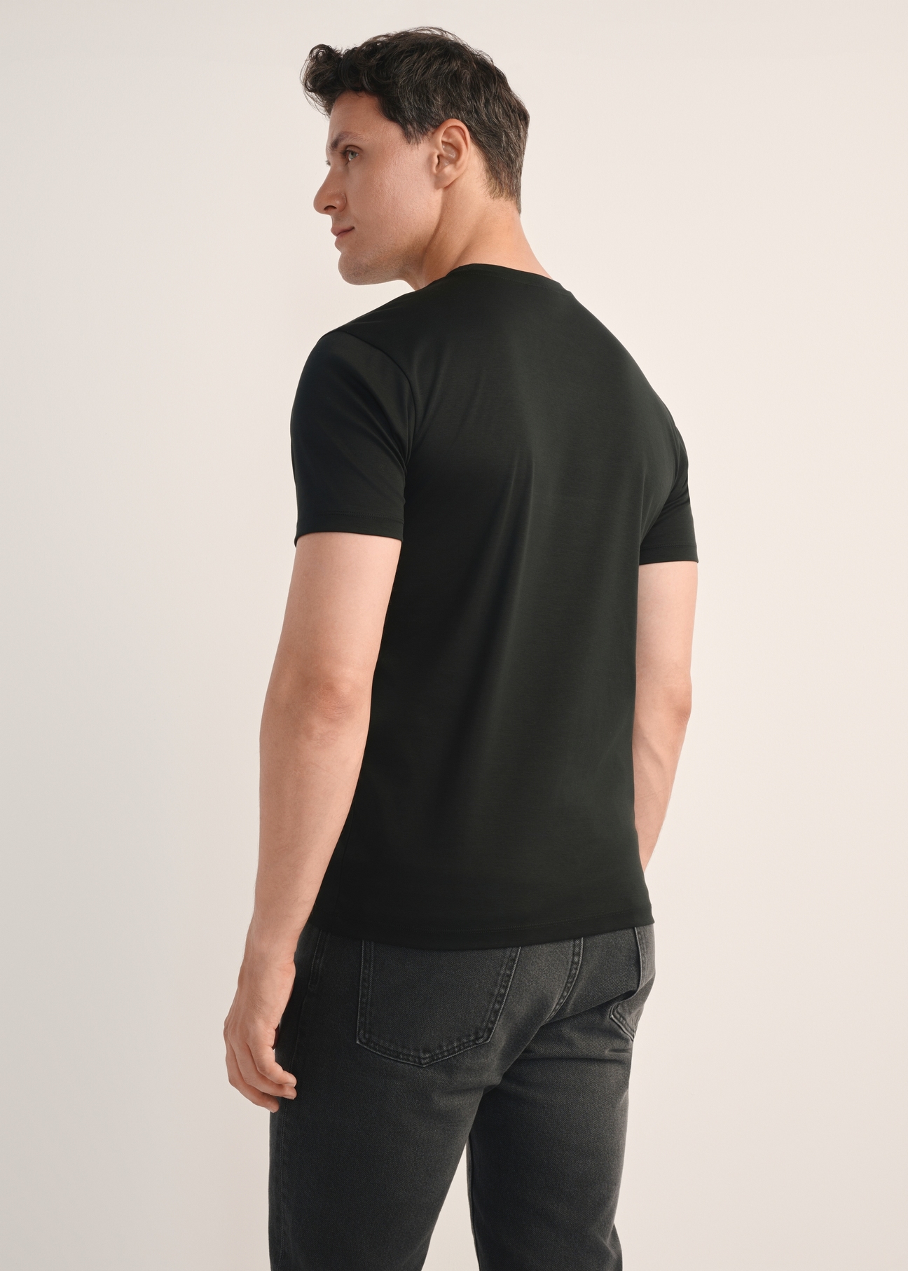 Men's black mercerized cotton T-shirt TSHMT-0135-99(Z25), back view of the product on the model. Half of the silhouette visible.