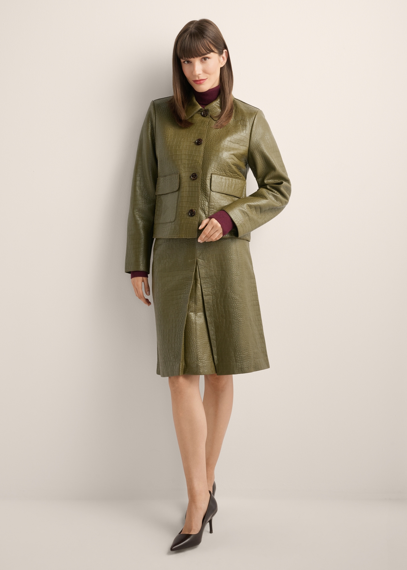 Women's olive green leather short jacket KURDS-0552-8E(Z26), front view of the product on the model. Full body visible.
