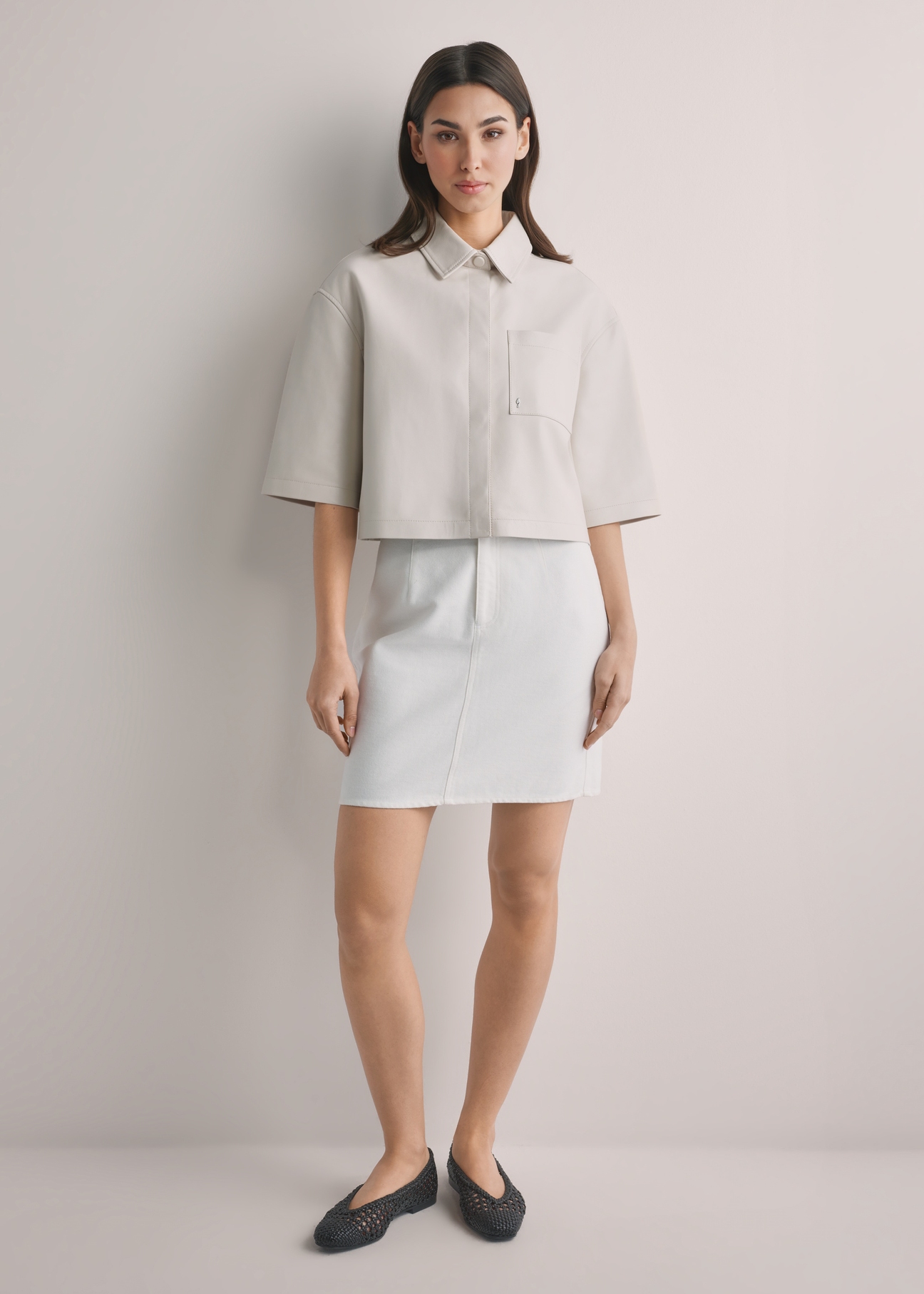 Cream denim mini skirt SPCDT-0126-0B(W26), front view of the product on the model. Full body visible.