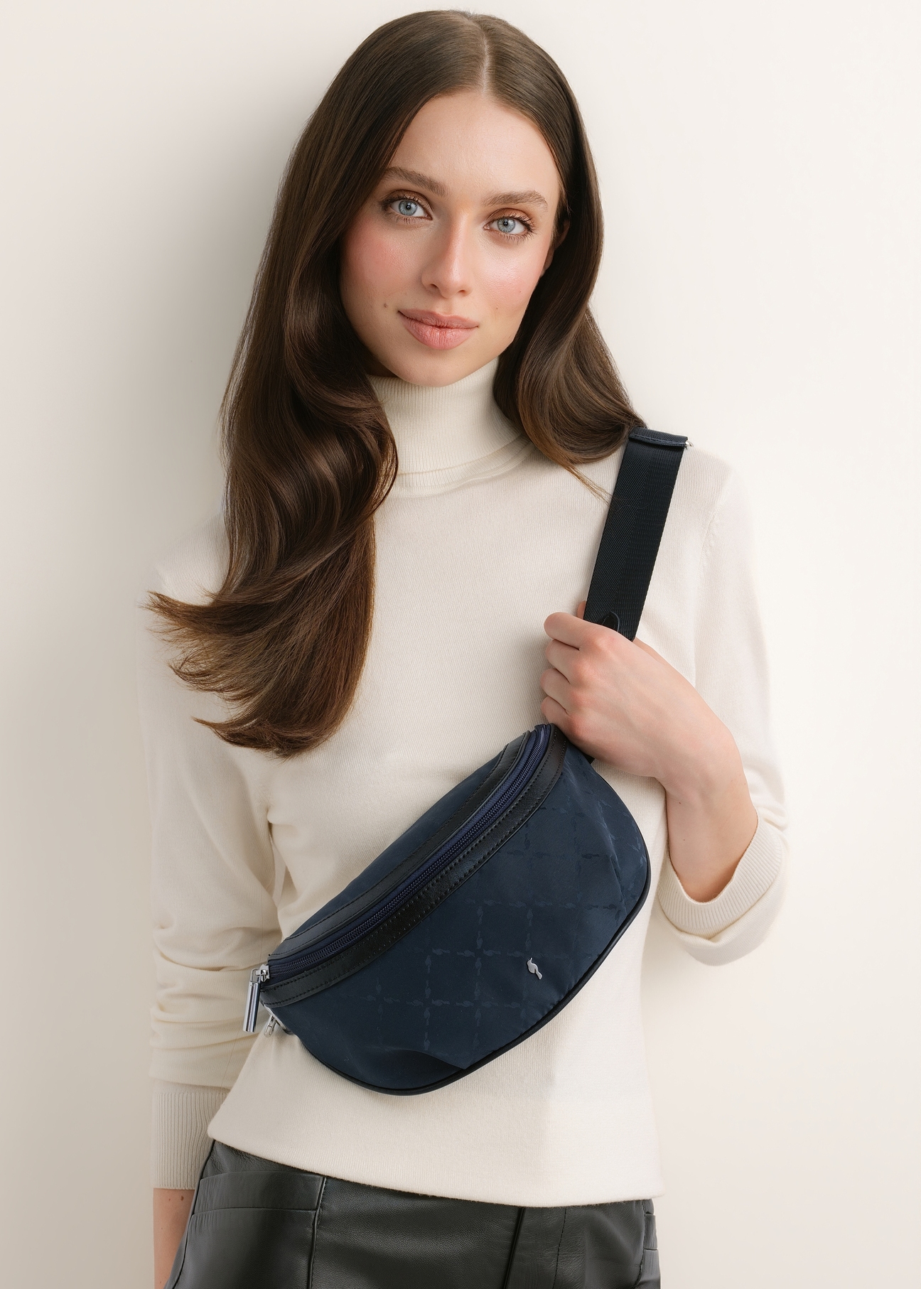 Navy blue women's belt bag with a monogram (TOREN-0356-7E(Z26)); front view of the product on a model against a light background.