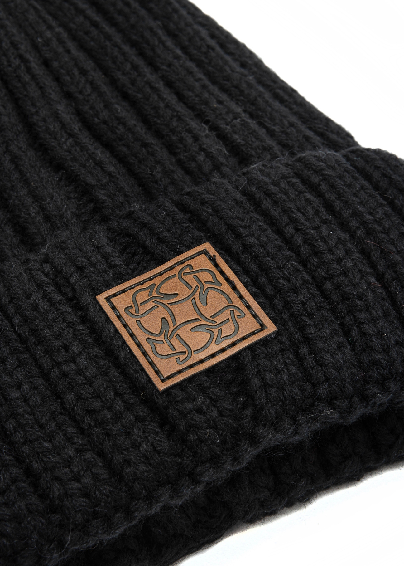 Black women's hat with pompom CZADT-0066A-99(Z25), close-up of the product logo on a white background.