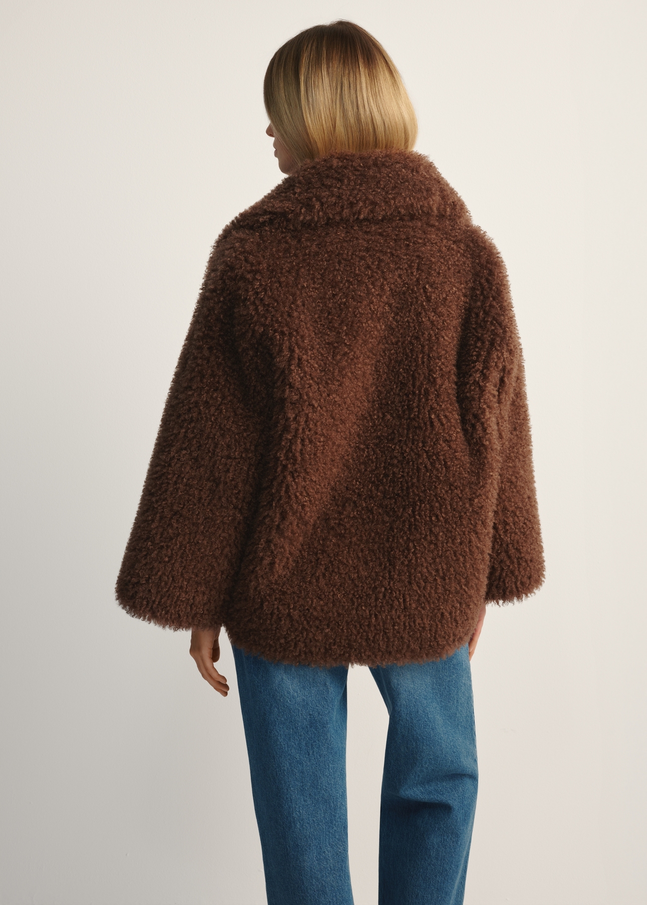 Brown short women's fur coat FUTDP-0076-89(Z25), product view from the back on the model, half of the silhouette visible.