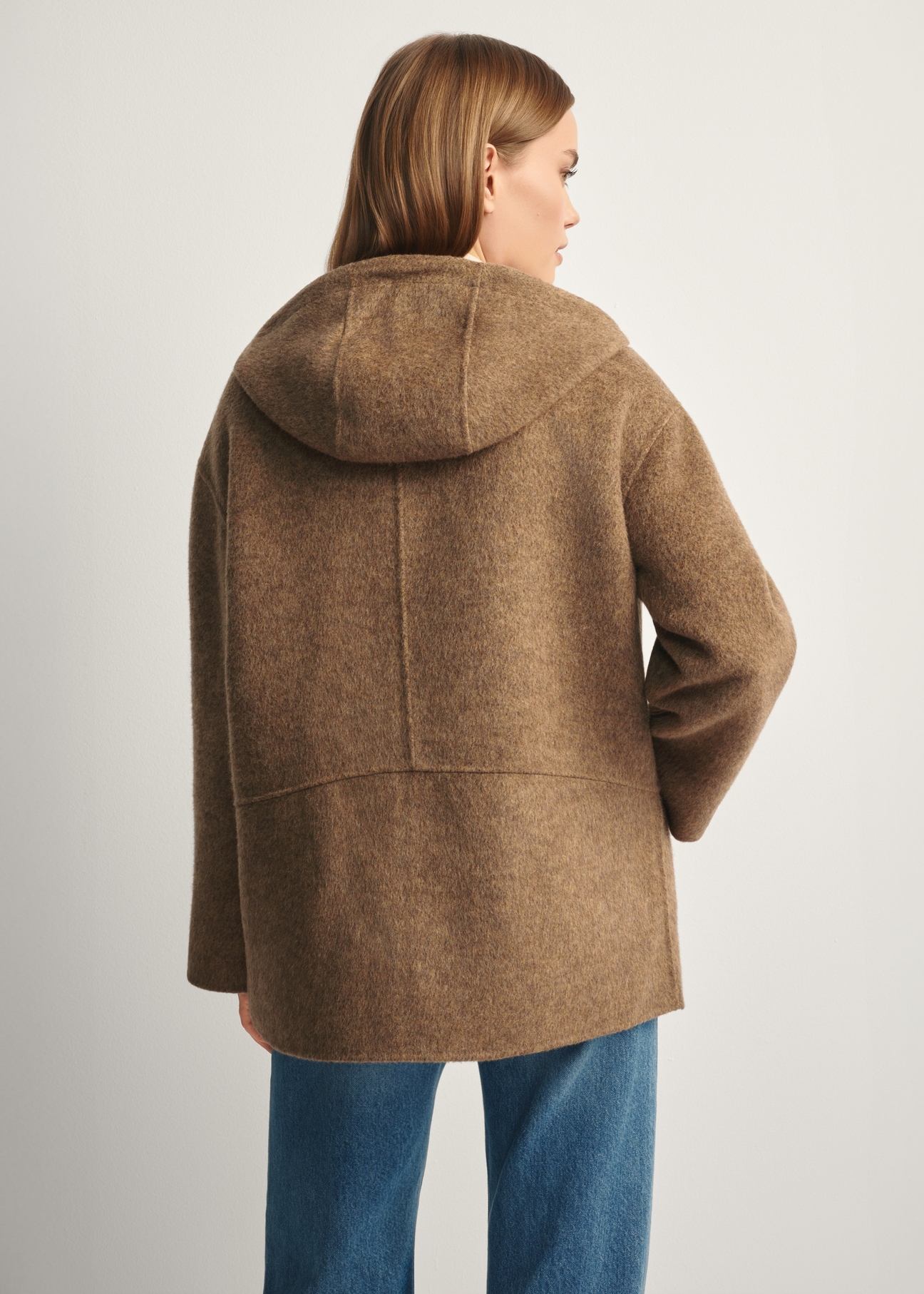 Brown woolen women's coat with hood PLADT-0064-89(Z25), product view from the back on the model, half of the silhouette visible.