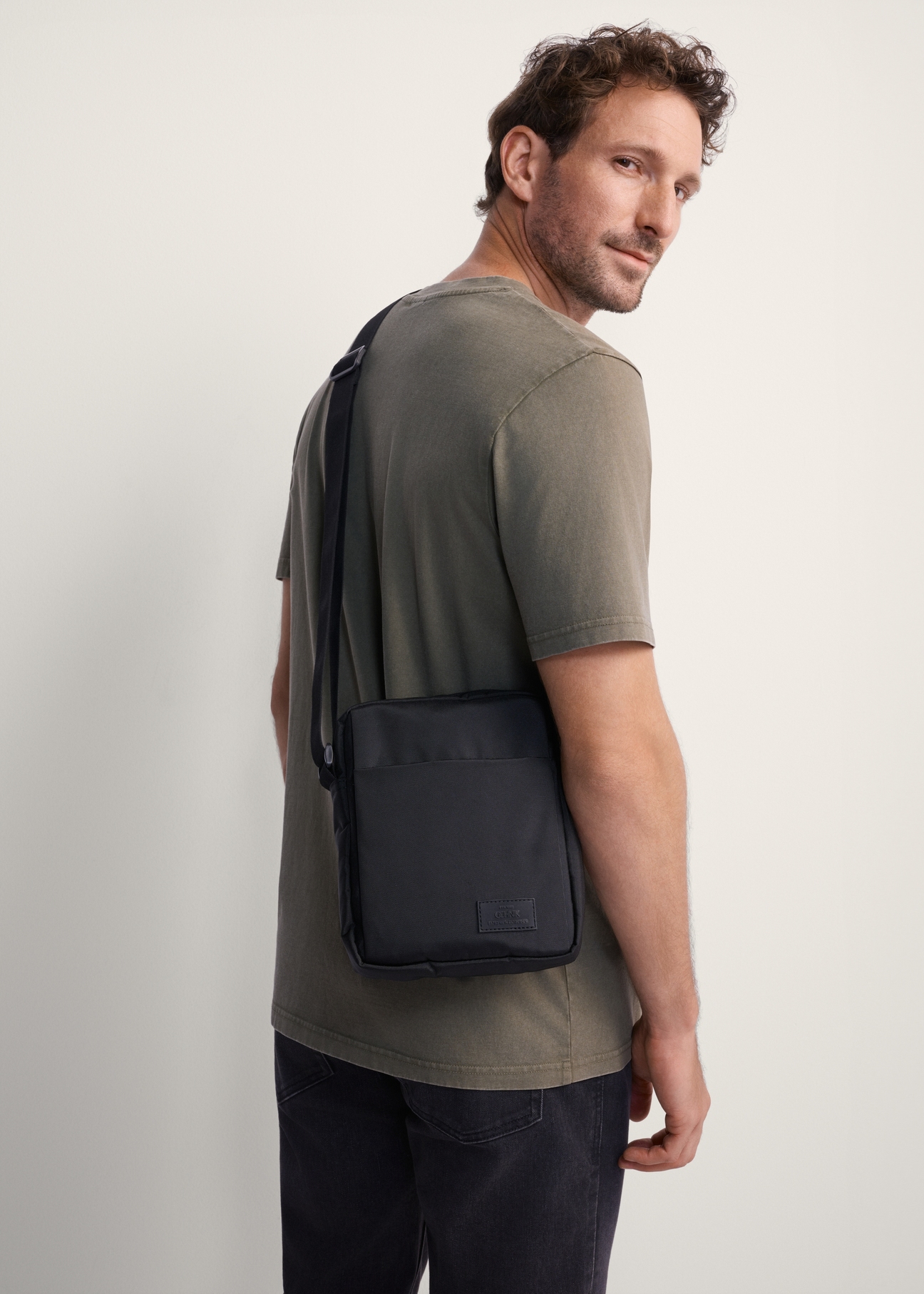 Black men's bag TORMN-0384-99(Z25), product view on model. Half of the silhouette visible.