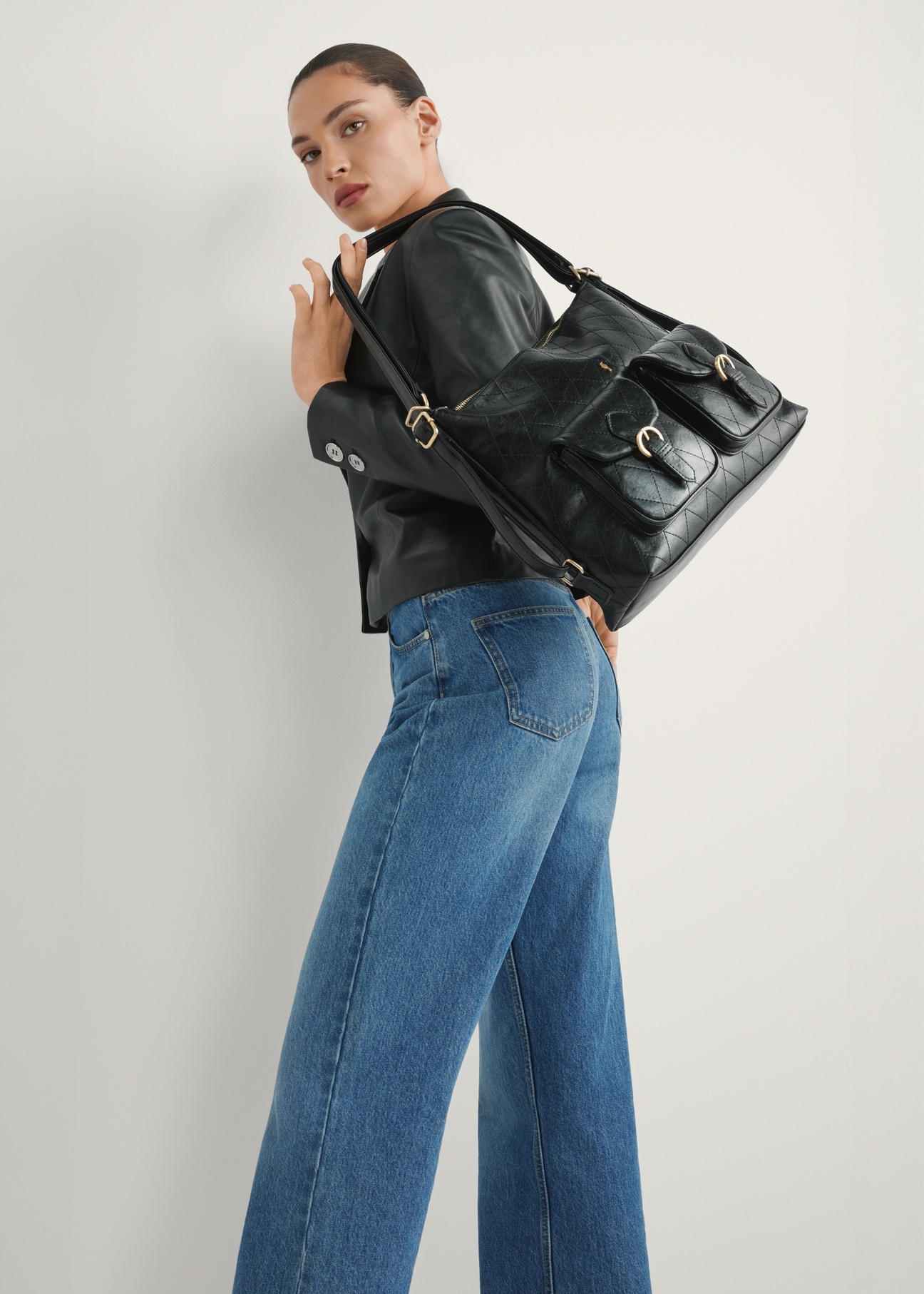 Black women's TOREC-1193-99(W26) backpack - product view slightly diagonal, against a light background. Knee-length silhouette visible.