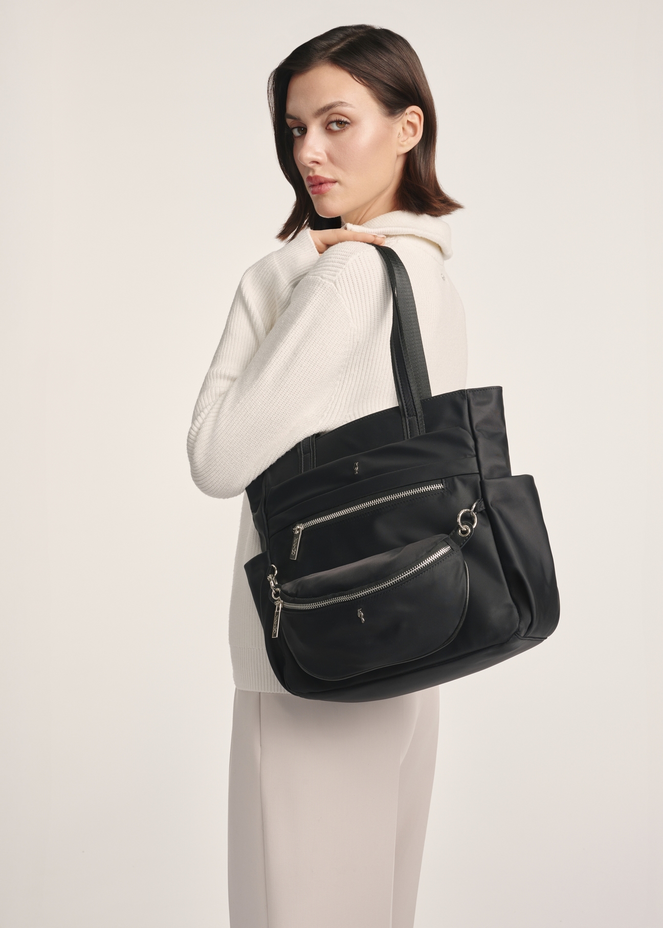 Women's nylon handbag with a pouch TOREN-0326-99(Z25), front view of the product on a model, half of the silhouette visible.