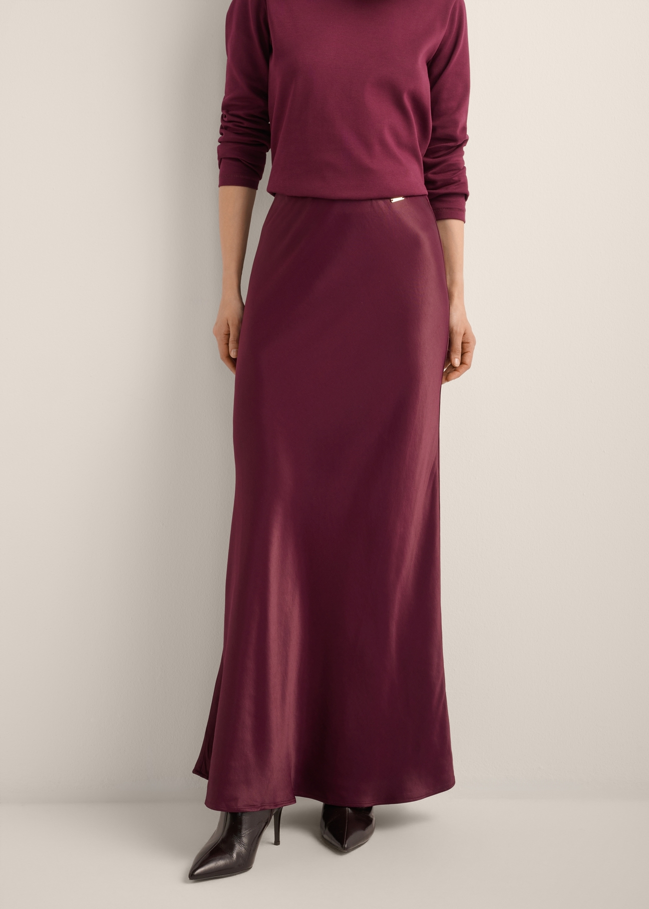 Women's burgundy long skirt SPCDT-0117-4D(Z26), front view of the product on the model. Half of the silhouette visible.