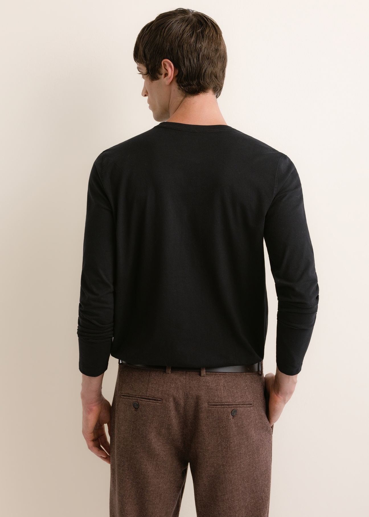 Men's black cotton long-sleeve top LSLMT-0013-99(Z26), rear view on a model. Half of the figure is visible.