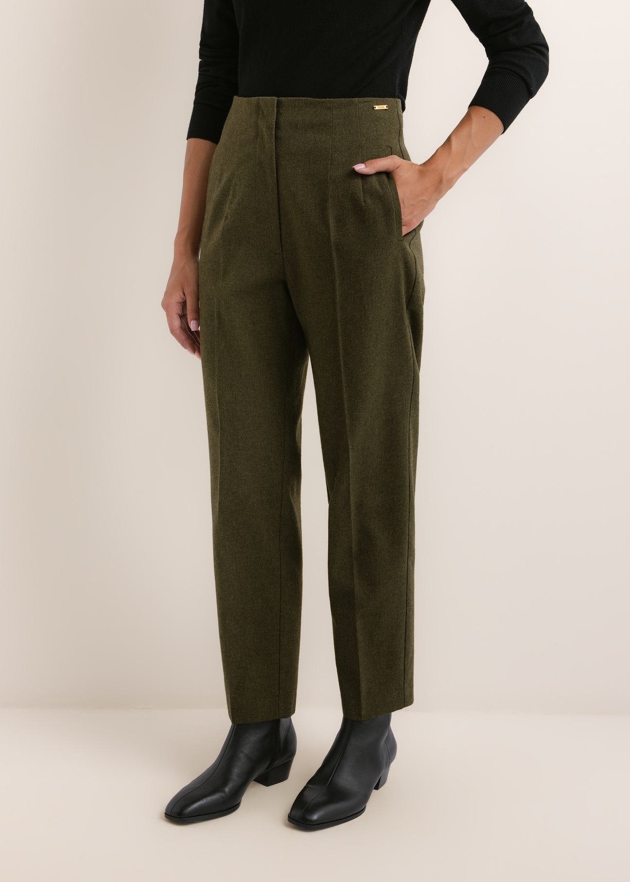 Green women's trousers with wool SPODT-0136-8B(Z26), front view of the product on the model. Half of the silhouette visible.