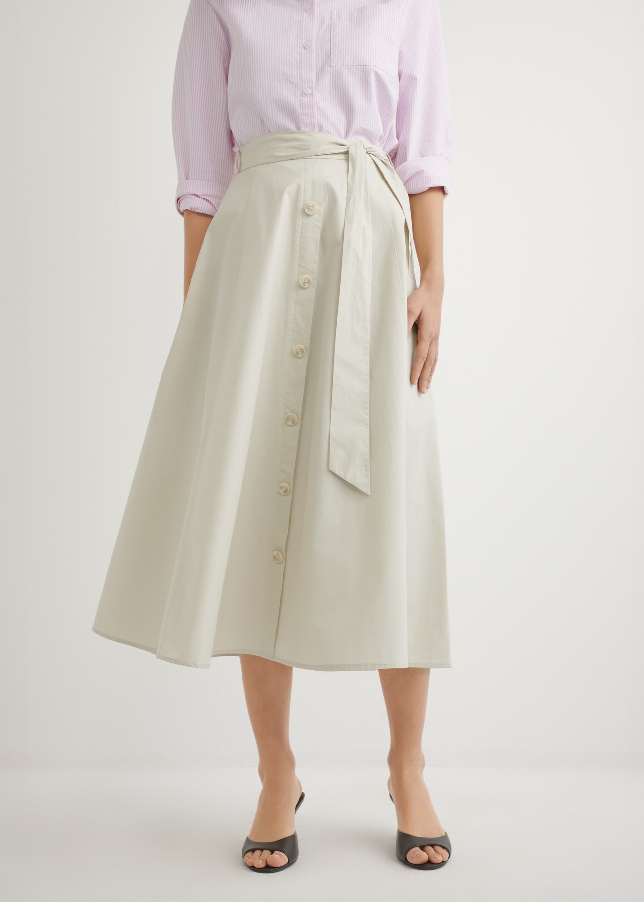 Beige midi skirt SPCDT-0123-1A(W26), front view of the product on the model. Half of the silhouette visible.