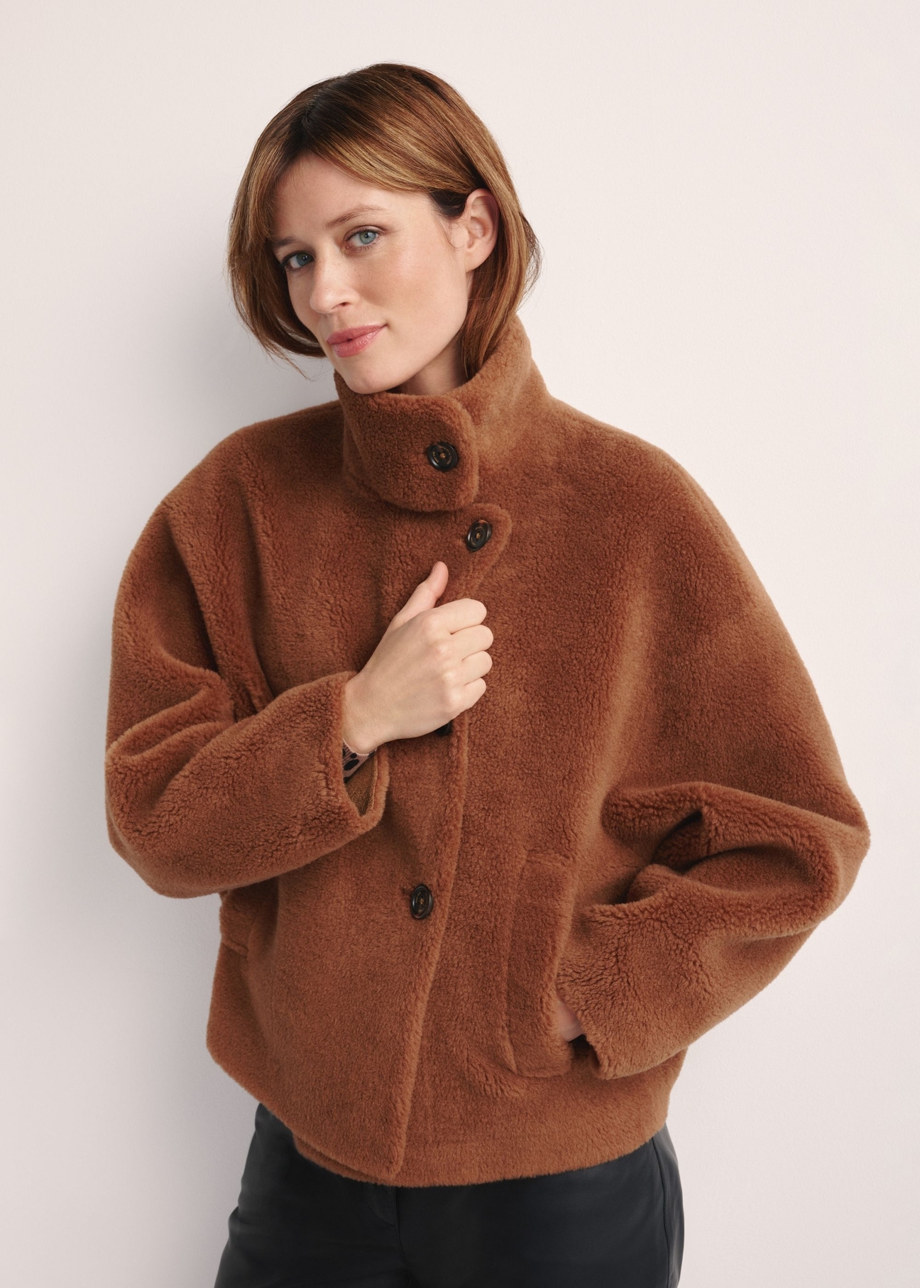 Brown woolen women's fur coat FUTDW-0033-1D(Z26), front view of the product on the model. Half of the silhouette visible.