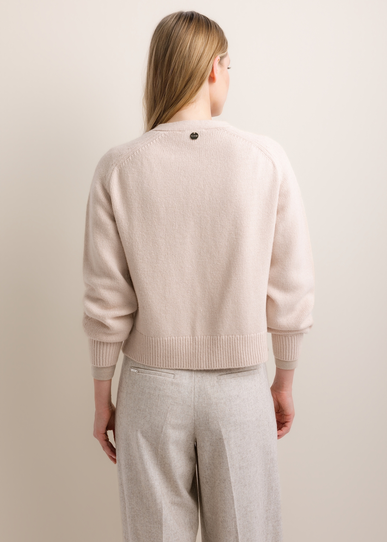 Light beige women's wool-blend cardigan KARDT-0071-1A(Z26), product view from the back on the model. Half of the silhouette visible.