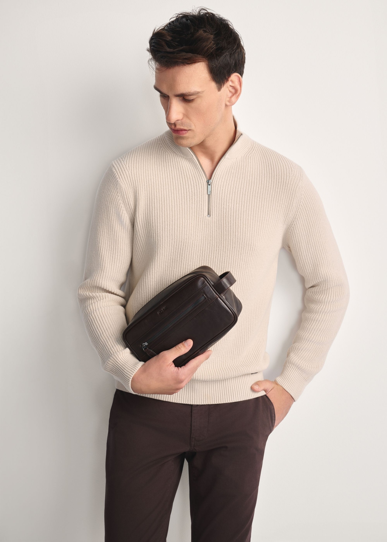 Brown men's cosmetic bag TORMS-0463-1H(Z26)  - front view of the product on a model against a white background. Half of the silhouette visible.
