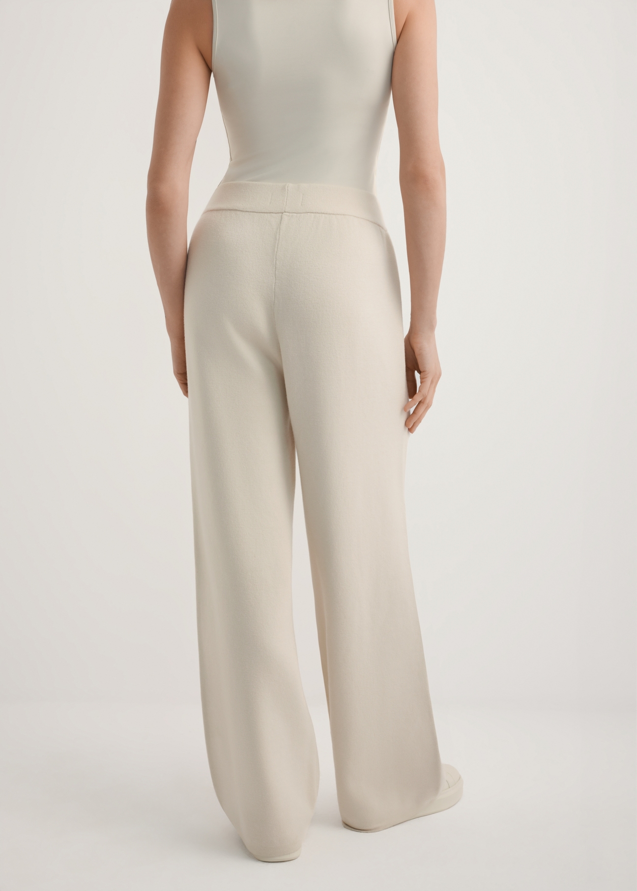Beige women's wide leg trousers SPODT-0121-1A(W26), back view of the product on the model. Half of the silhouette visible.