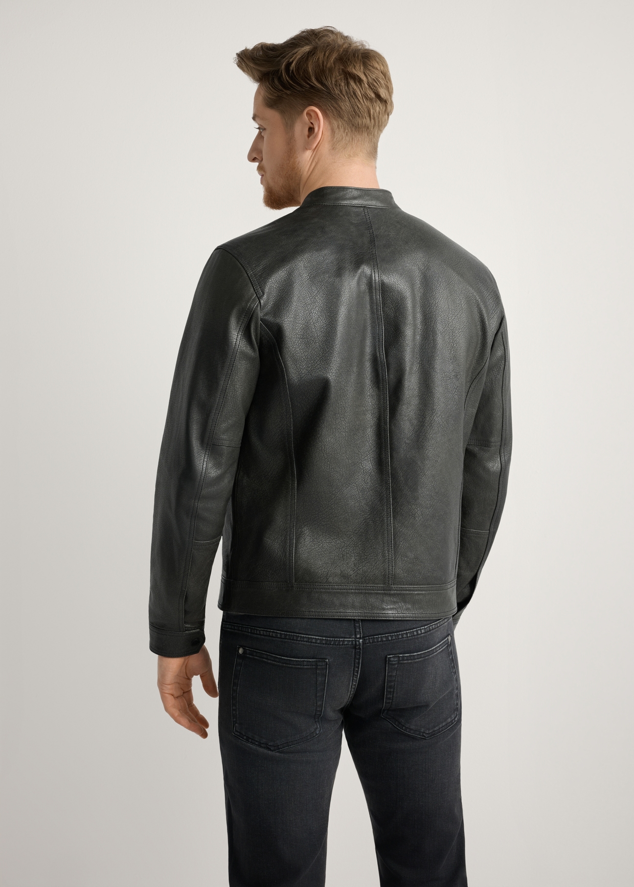 Black men's leather jacket KURMS-0406-99(W26) - back view of the product, on a model, against a light background. Knee-length silhouette visible.