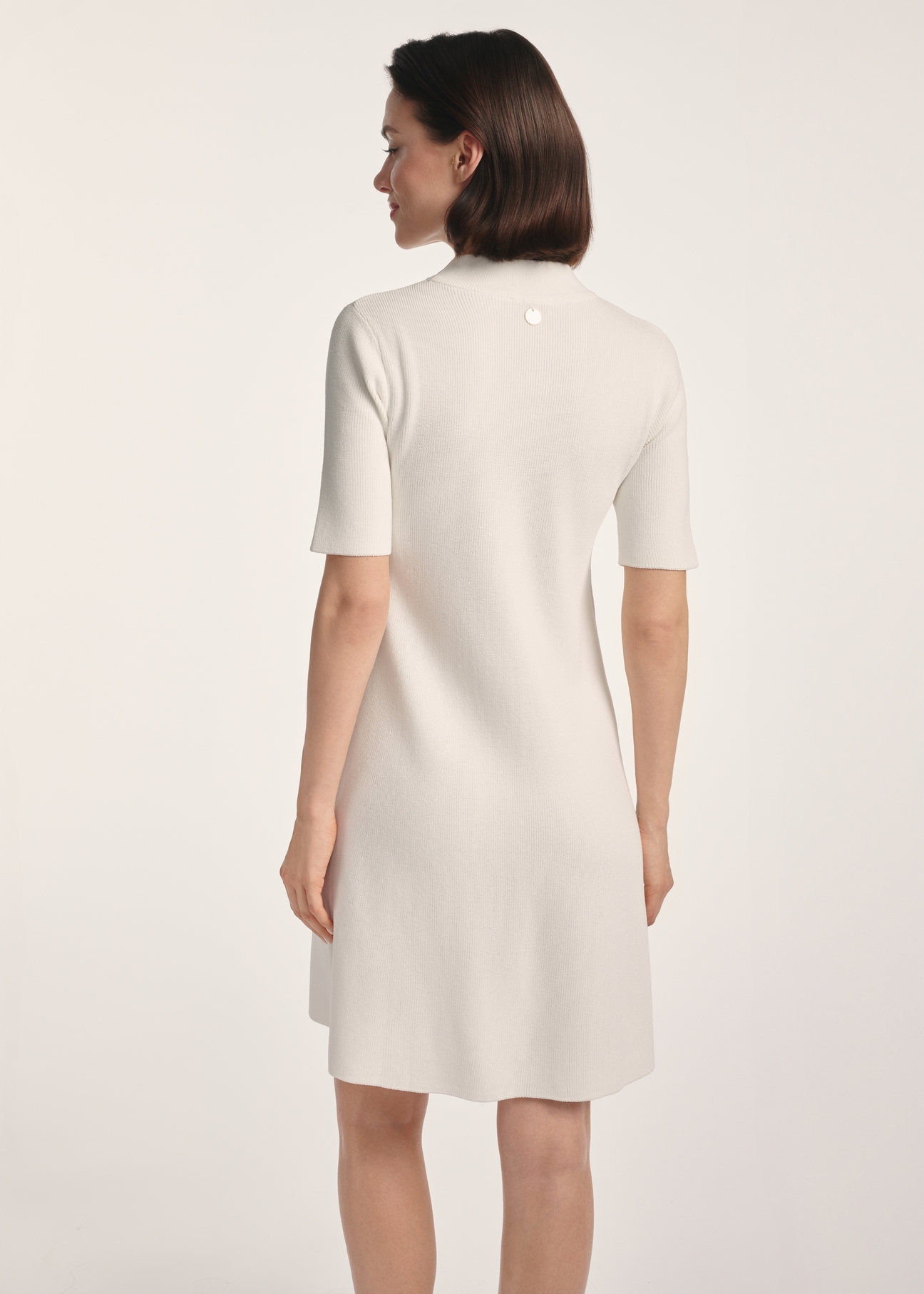 Cream women's dress SUKDT-0243-12(Z25), product visible from the back on the model, half of the silhouette visible.