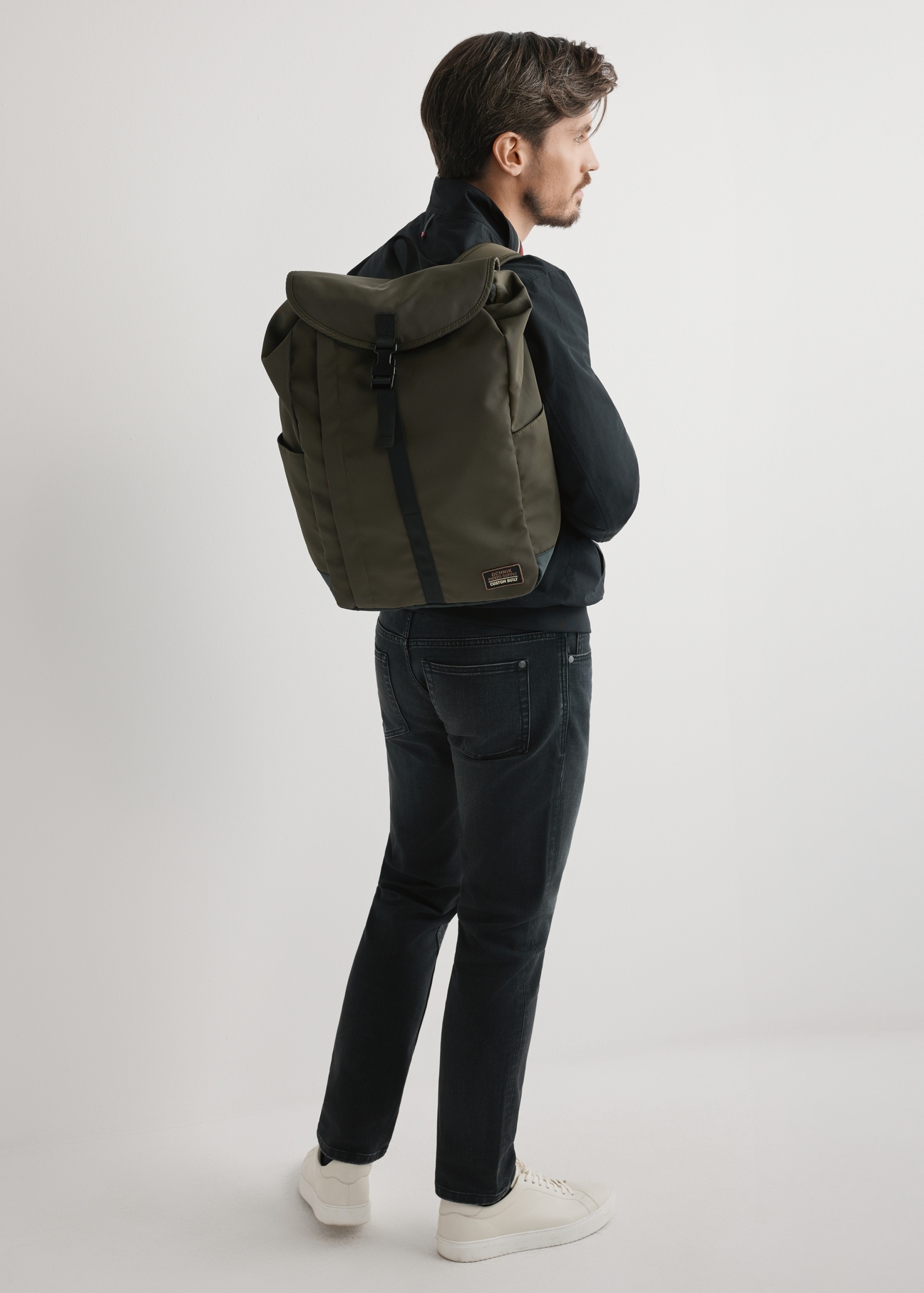 Men's khaki backpack TORMN-0415-8D(W26) - front view of the product, on a model, against a light background. Full body visible.