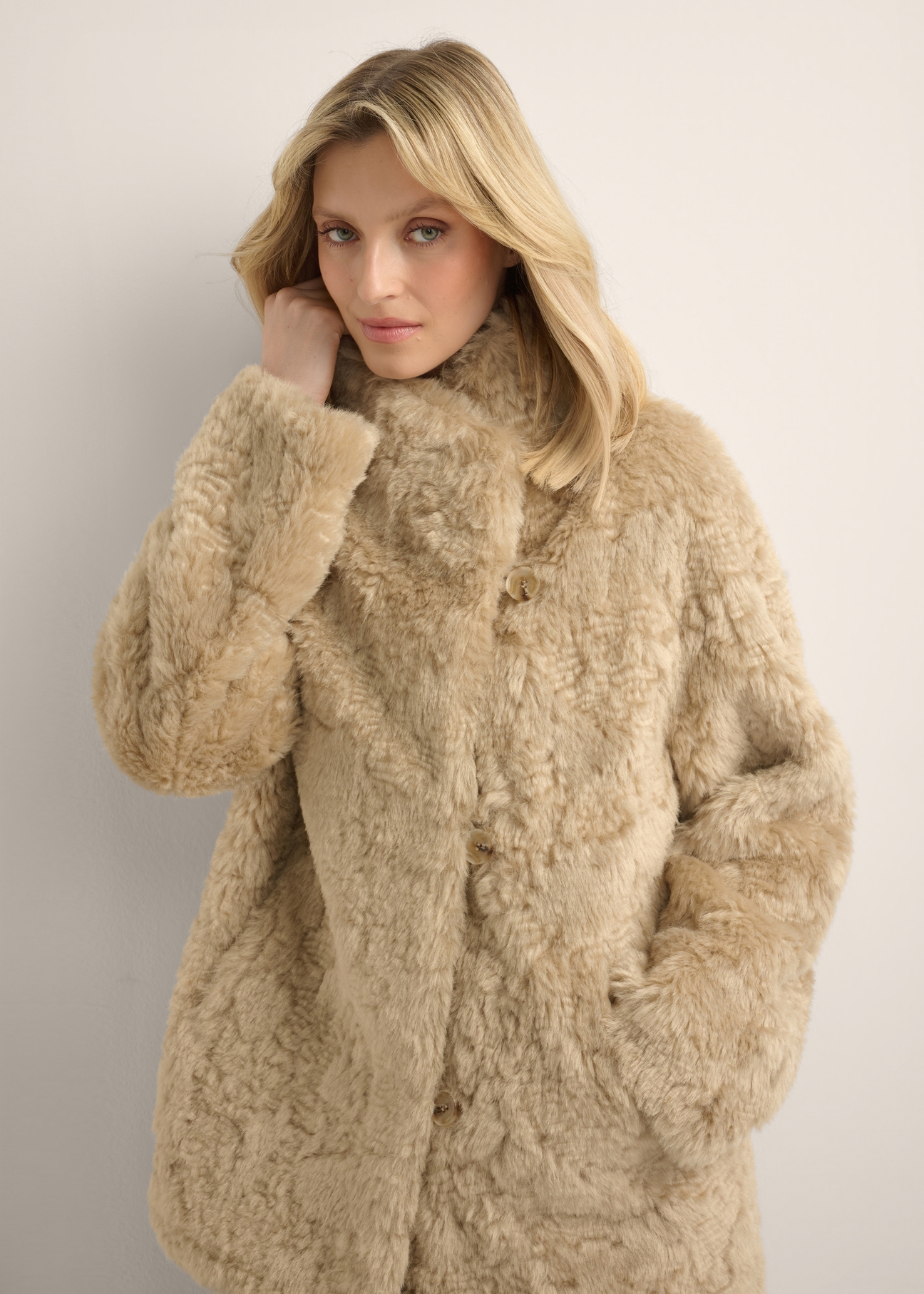 Women's short light beige fur coat FUTDP-0088-1A(Z26), front view of the product on the model. Half of the silhouette visible.