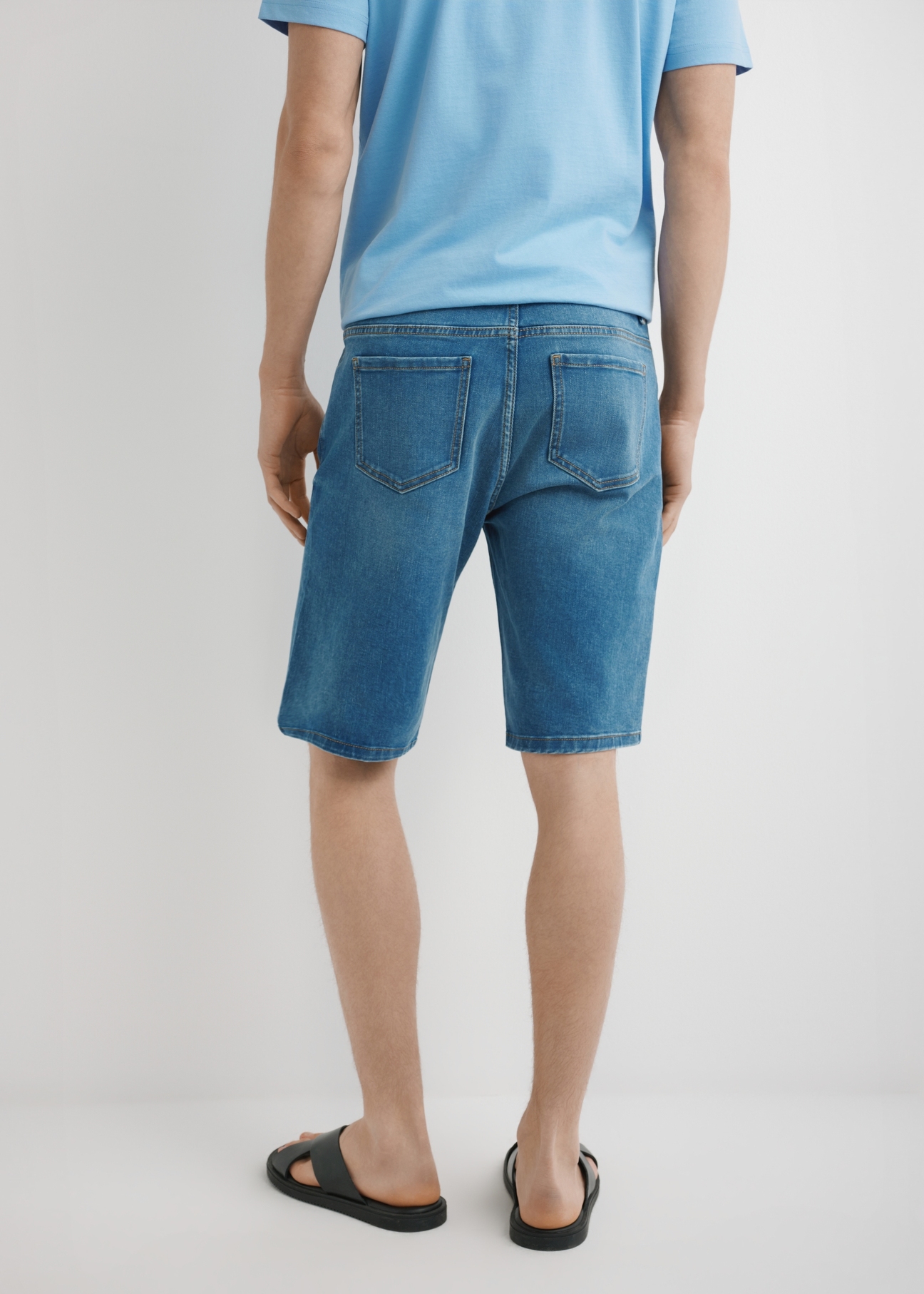 Men's blue denim shorts SZOMT-0036-7H(W26) - back view of the product on the model, against a light background. Half of the silhouette visible.
