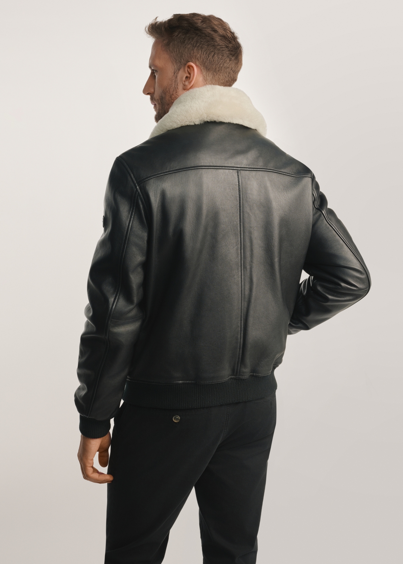 Black men's leather pilot jacket KURMS-0378-2745(Z25), product view from the back on the model, half of the silhouette visible.
