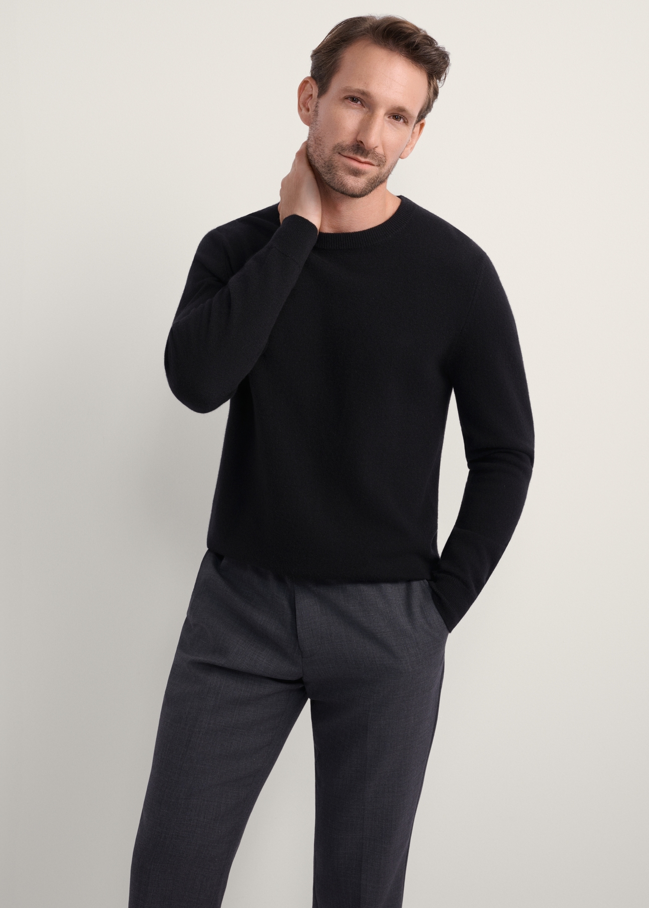 Black men's wool cashmere sweater SWEMT-0186-99(Z25), front product view on model. Half silhouette visible.