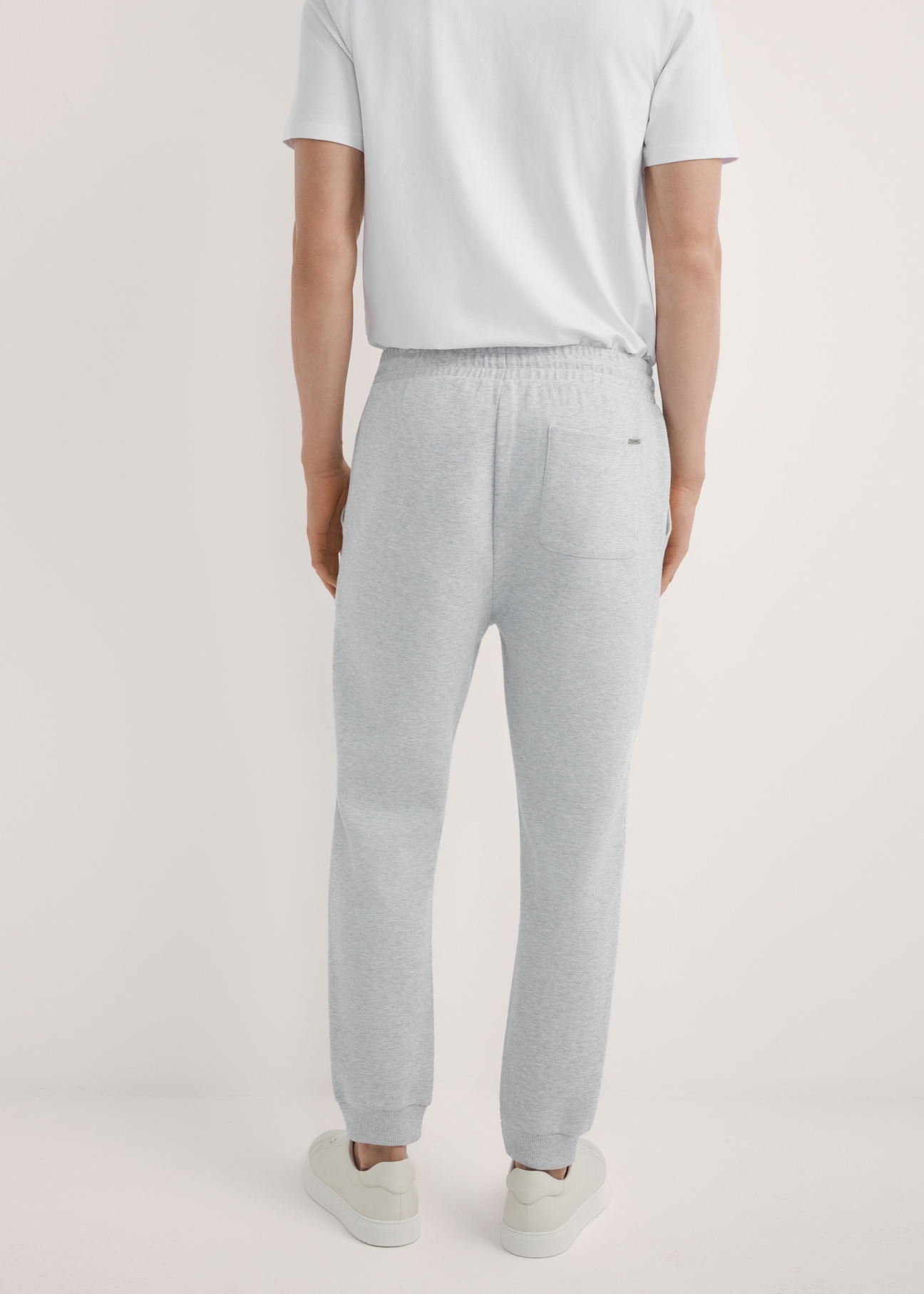 Men's gray sweatpants SPOMT-0116-9A(W26), product view from the back on the model. Half of the silhouette visible.