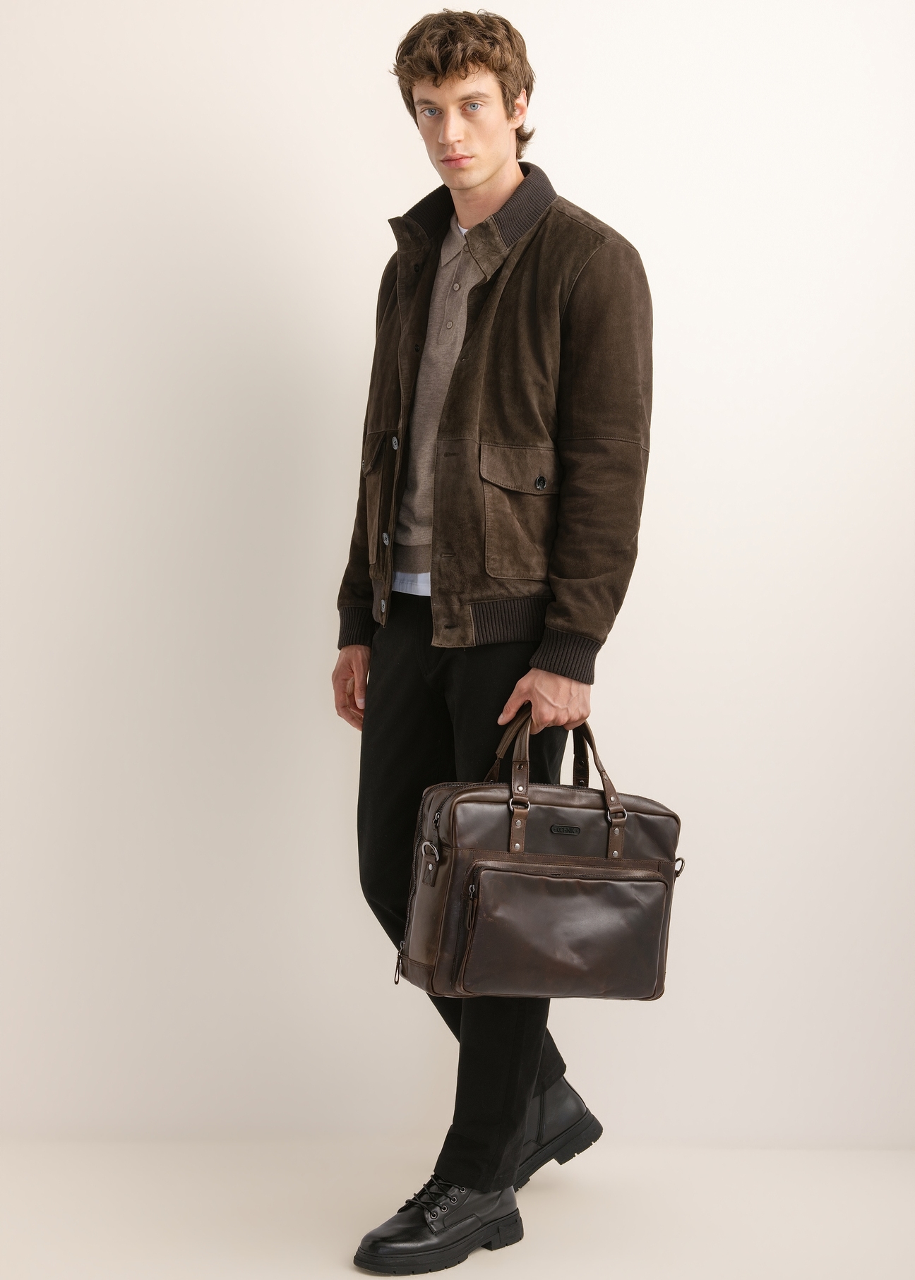 Brown leather men's bag TORMS-0542-1I(Z26), front view of the product in the model's hand.