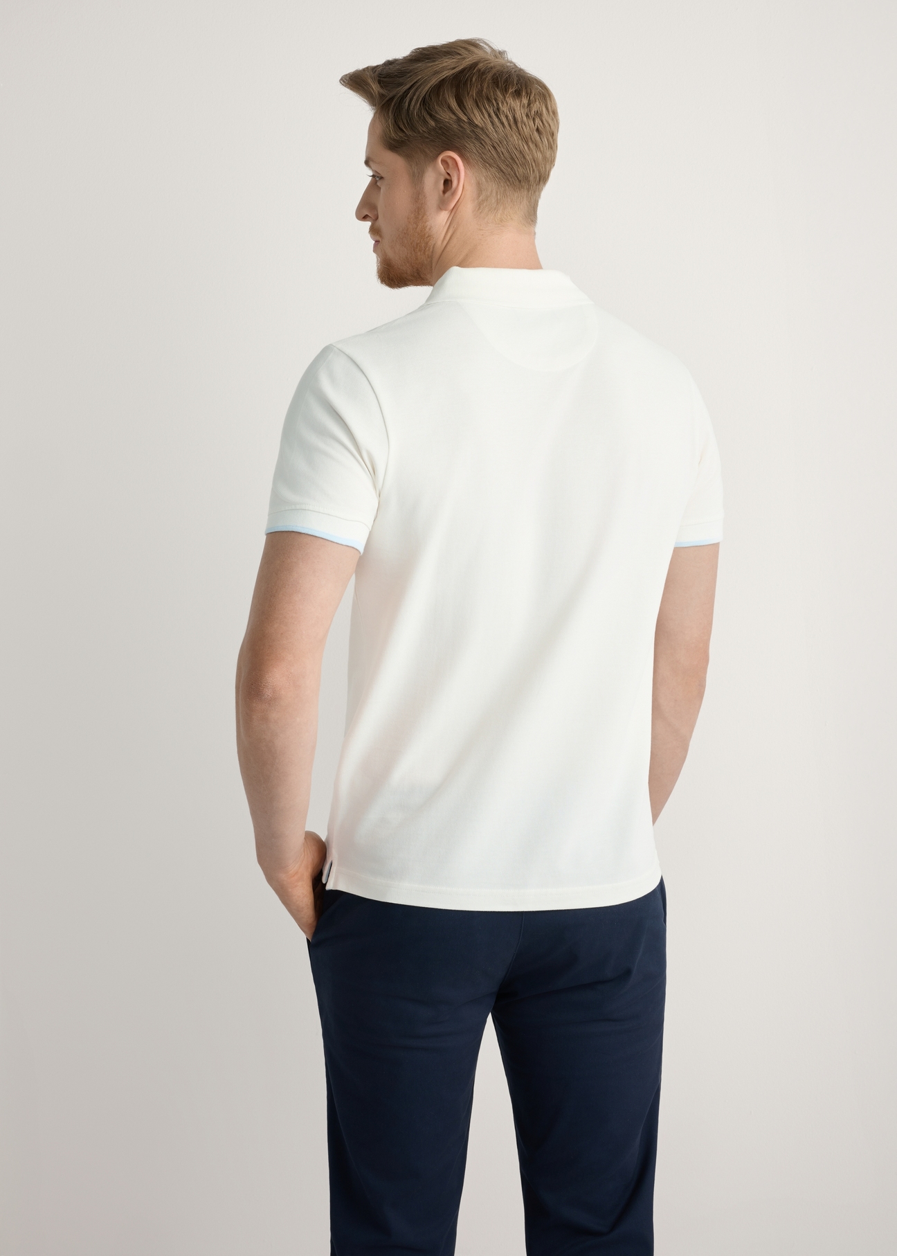 Cream cotton polo shirt POLMT-0045B-0B(W26), back view of the product on the model. Half of the silhouette visible.