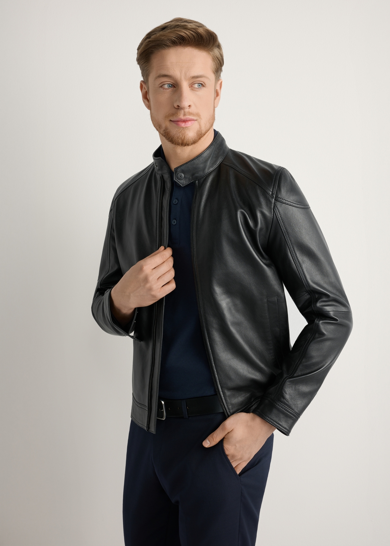 Men's leather jacket with stand-up collar KURMS-0301-99(W26), front view of the product on the model, half of the silhouette visible.-02