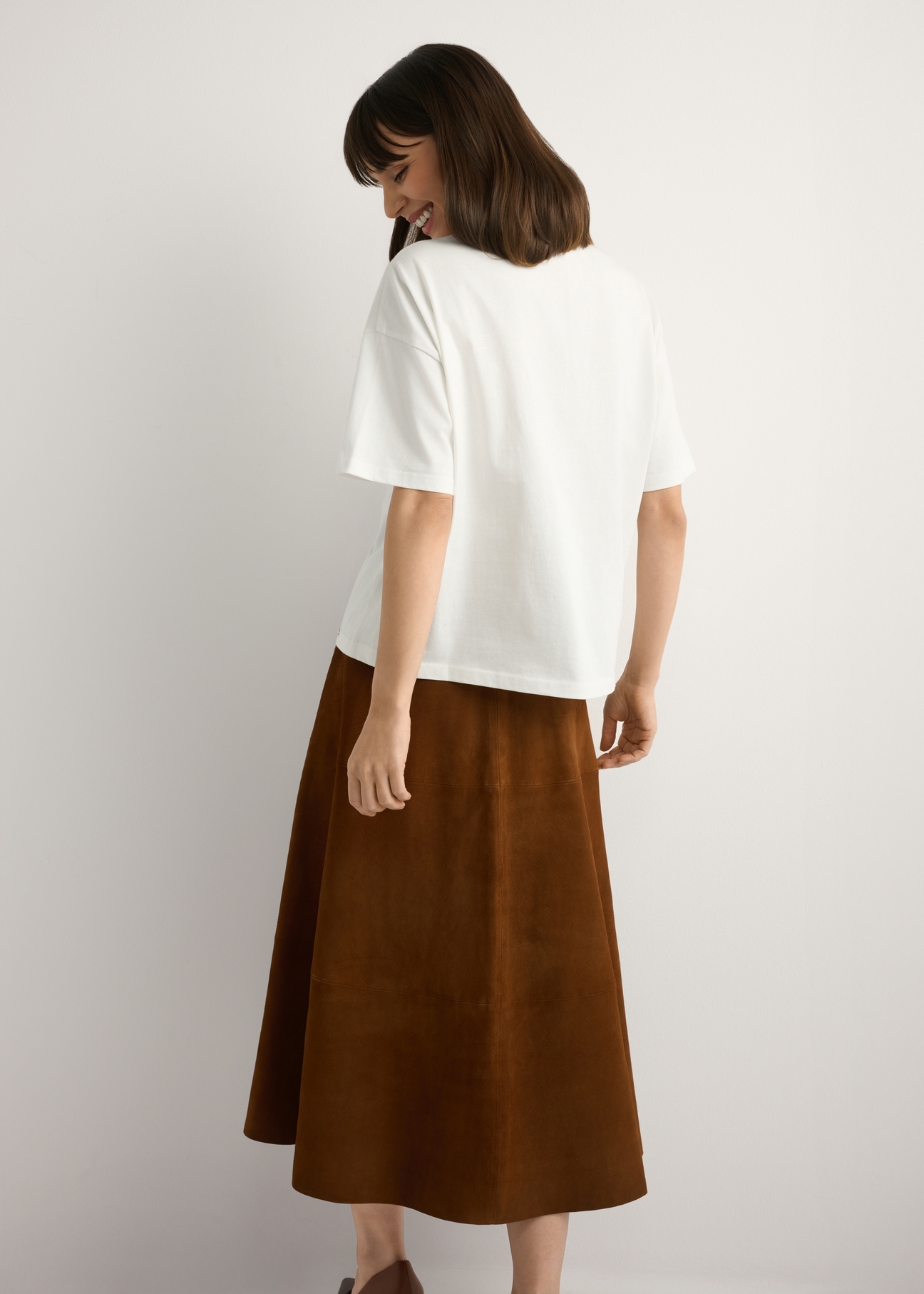 Women's white T-shirt with print TSHDT-0153-0B(W26), back view of the product on the model. Half of the silhouette visible.