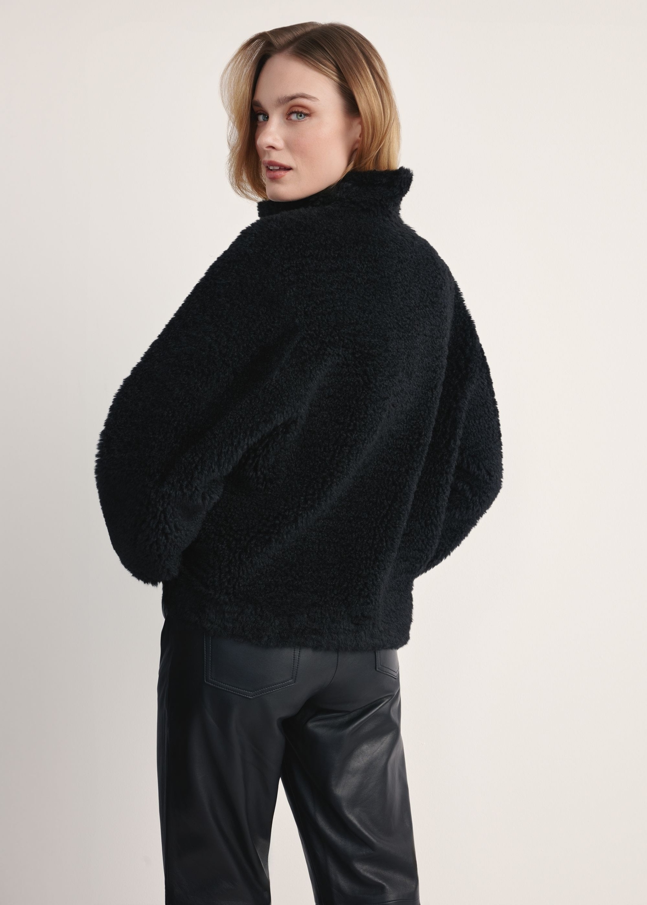 Women's black fur coat FUTDP-0021C-99(Z26), back view of the product on the model. Half of the silhouette visible.