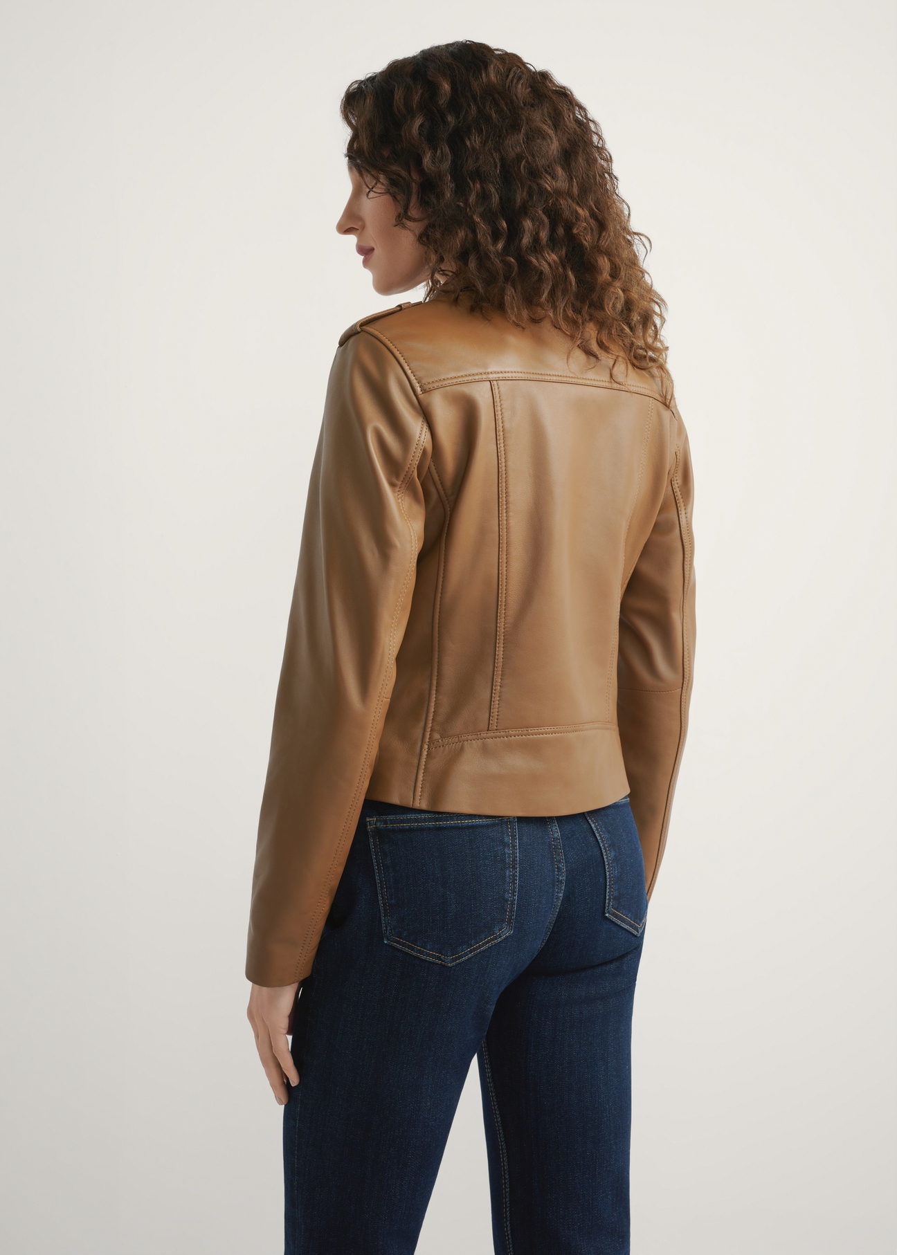 Women's beige leather jacket KURDS-0601-1B(W26), back view of the product on the model. Half of the silhouette visible.