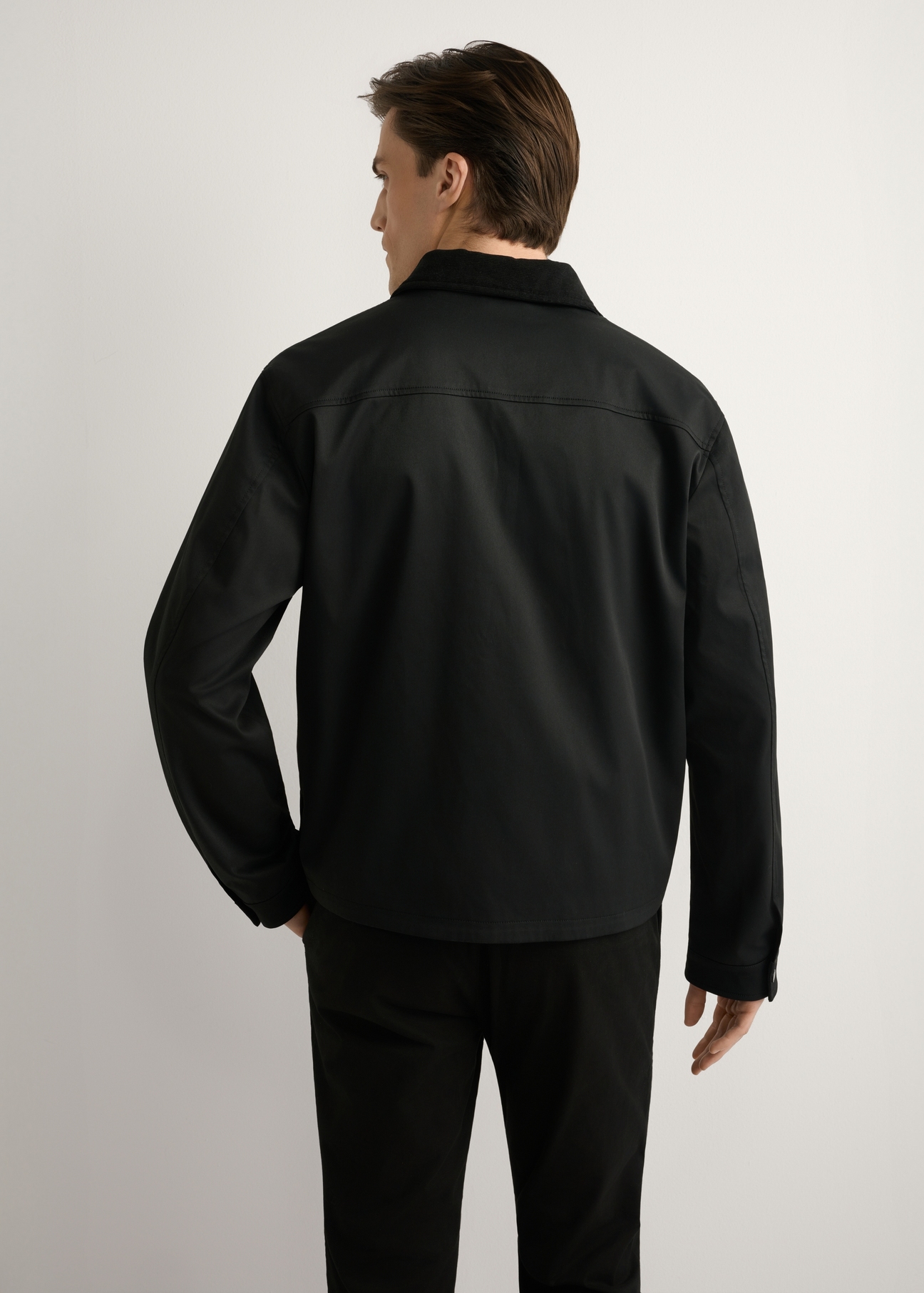 Men's black transitional jacket KURMT-0419-99(W26) - product view from the back, on a model, against a light background. Knee-length silhouette visible.