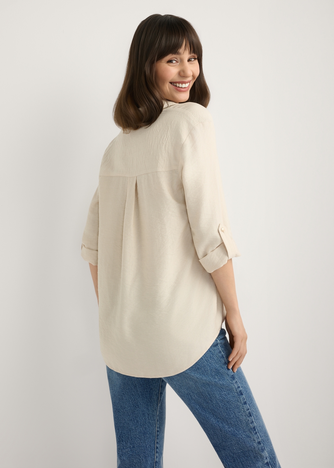 Light beige women's shirt KOSDT-0157A-1A(W26), back view of the product on the model. Half of the silhouette visible.