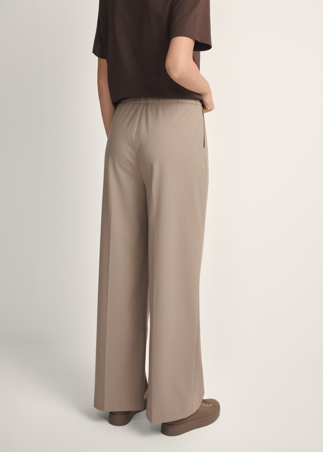 Women's dark beige trousers SPODT-0119-1K(W26), back view of the product on the model. Half of the silhouette visible.