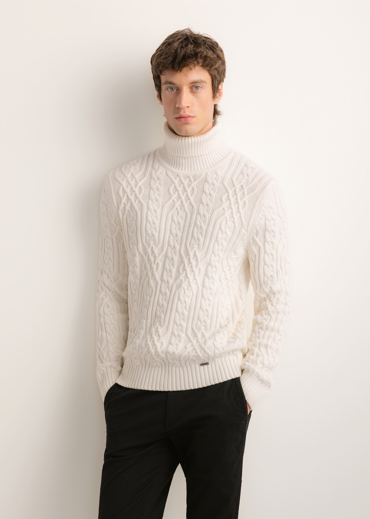 Men's cream turtleneck with decorative weave SWEMT-0206-0B(Z26), front view of the product on the model. Half of the silhouette visible.
