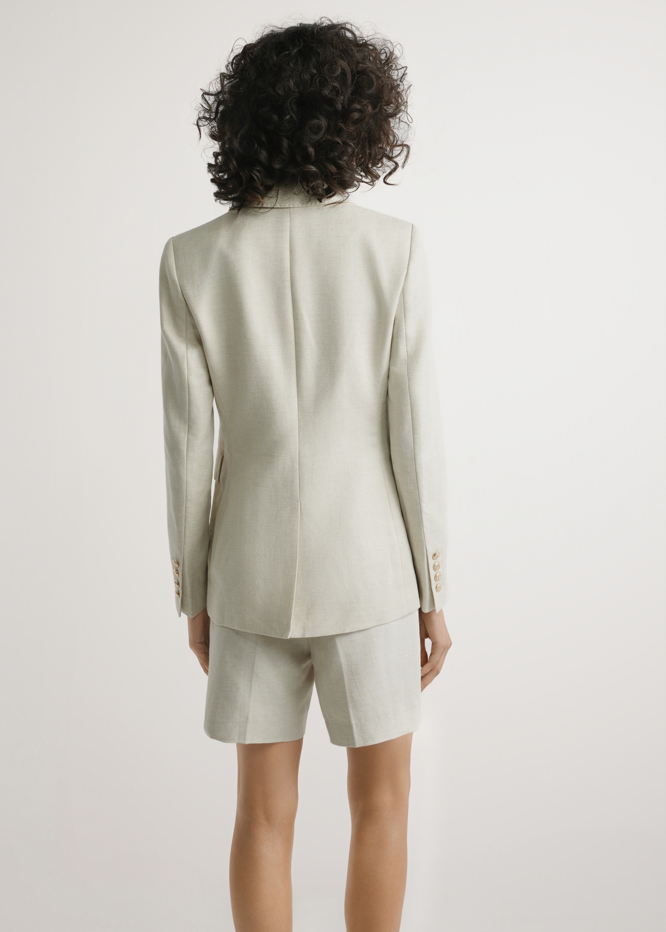 Women's light beige linen blazer ZAKDT-0049-1A(W26), back view of the product on the model. Half of the silhouette visible.