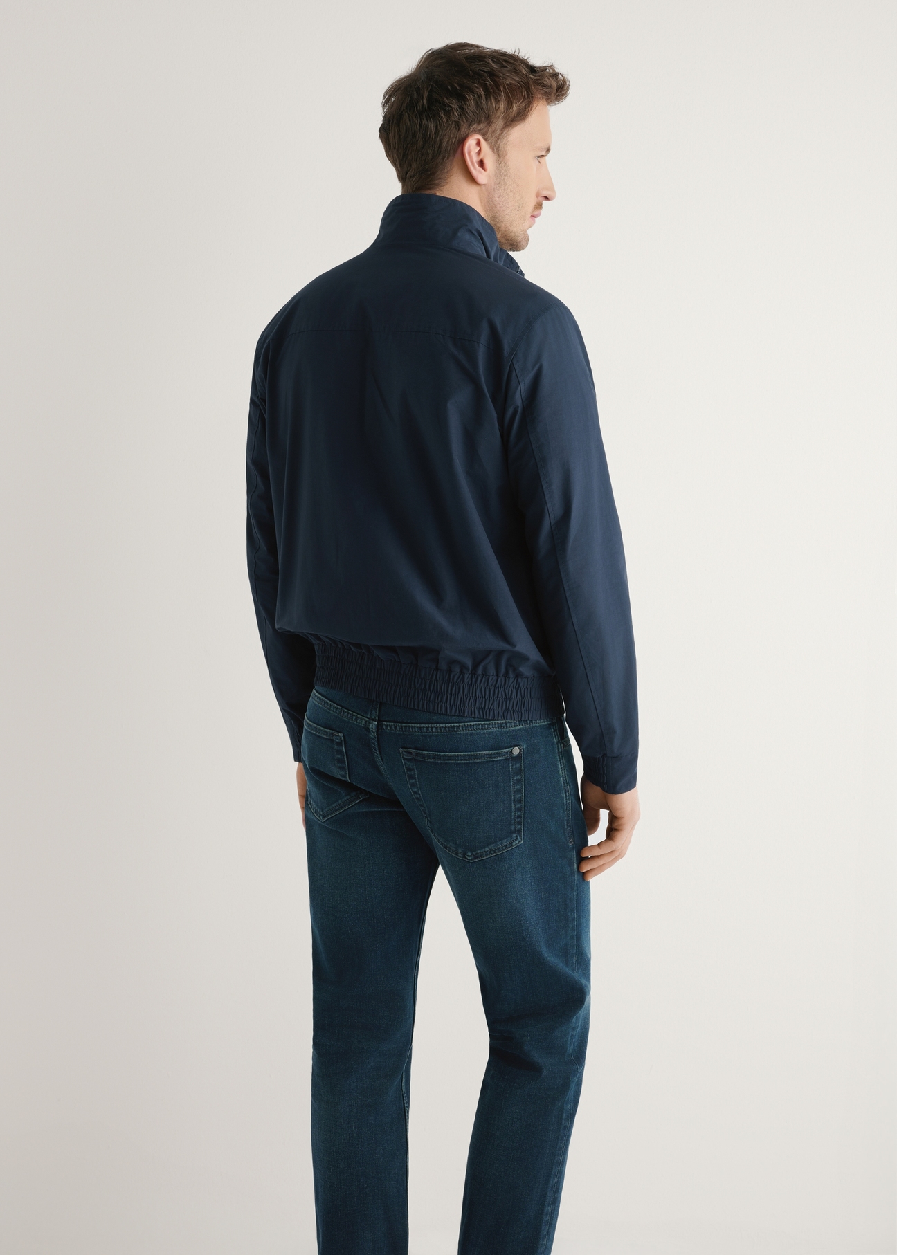 Men's navy blue transitional jacket KURMT-0417-7E(W26) - product view from the back, on a model, against a light background. Half-length silhouette visible.