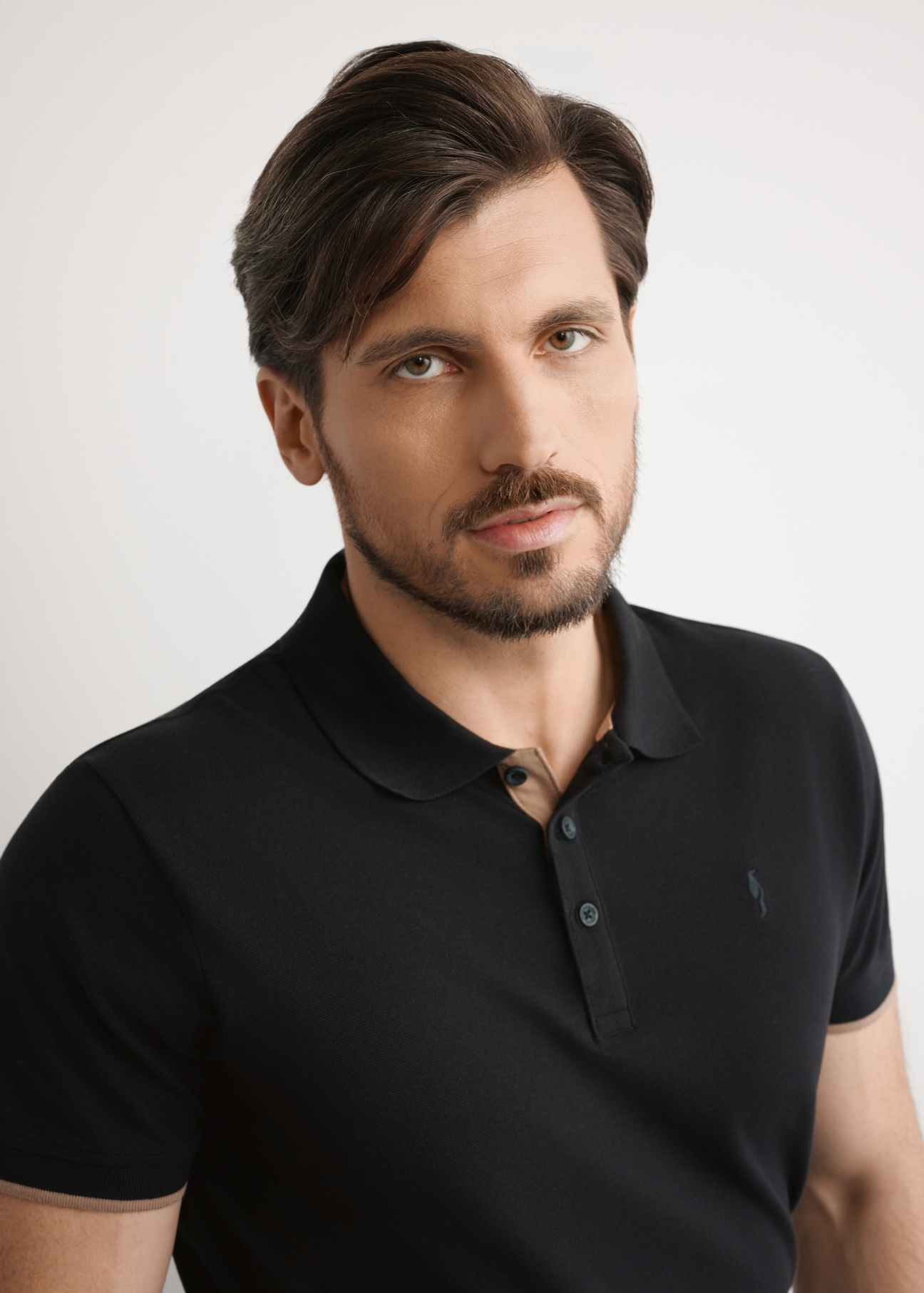 Men's black cotton polo shirt POLMT-0045B-99(W25), close-up of the product on the model's silhouette.